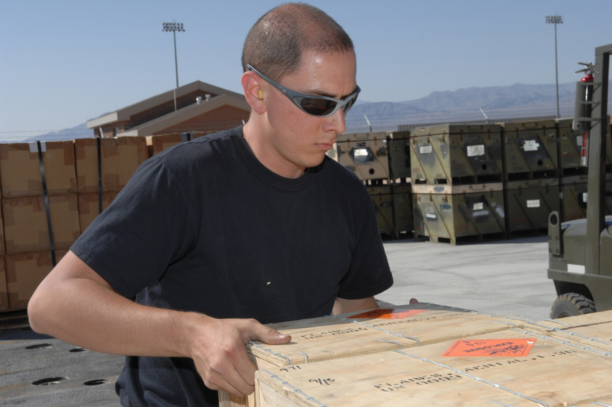 Staff Sergeant Anthony Pimentel, a line delivery crew chief with the 57th Equipment Maintenance Squadron's Munitions Flight, loads a box of munitions onto a pallet in preparation to store Tuesday May 15, 2007 Nellis Air Force Base, Nevada. The line delivery crew stores and delivers assets to weapons loading crews on the flight line.(U.S Air Force Photo by/ Senior Airman Larry E. Reid Jr.)
