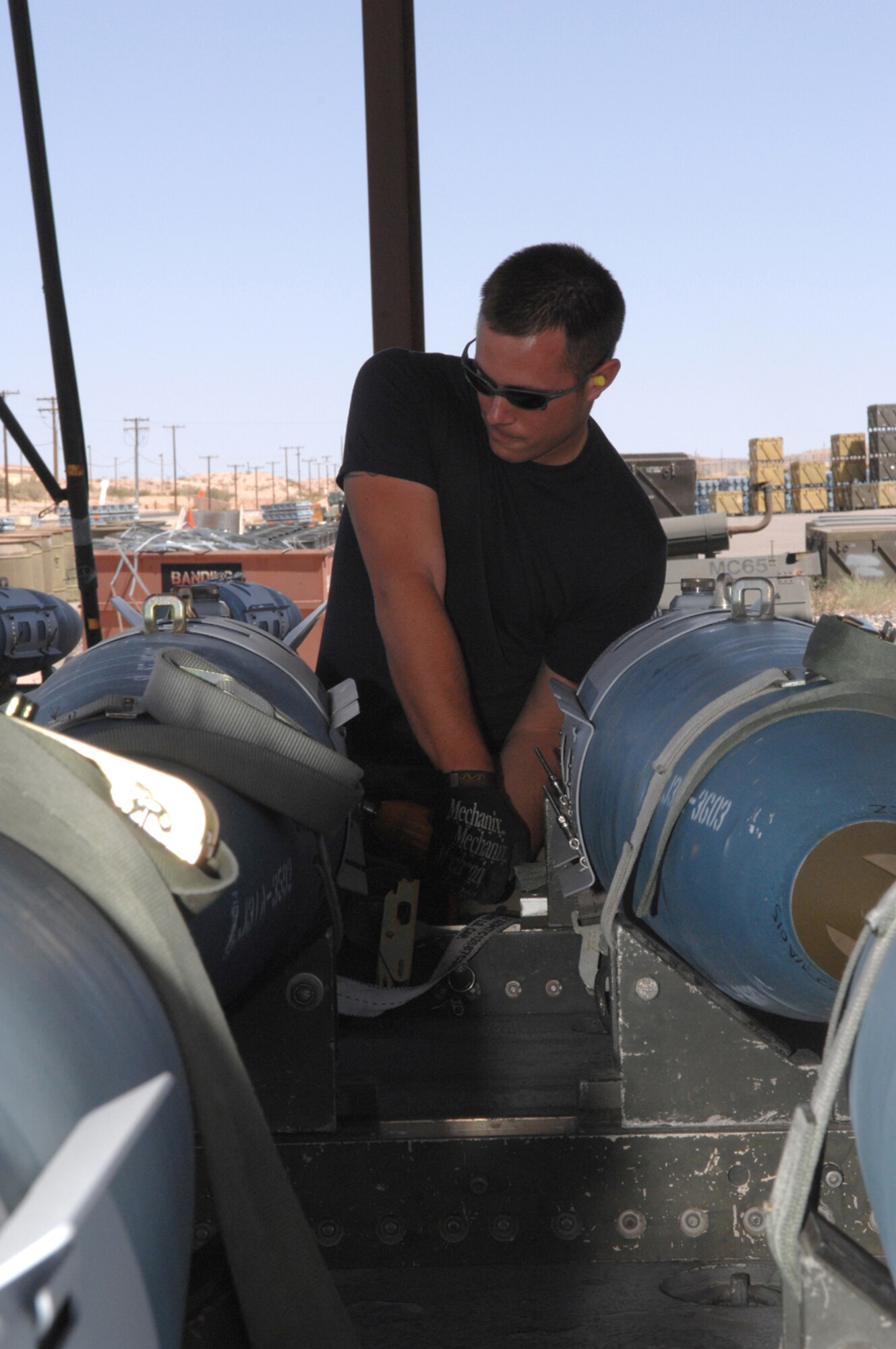 Senior Airman Jason Brackins, a Big Bombs crew chief assigned to the 57th Equipment Maintenance Squadron's Munitions Flight, tightens screws on a fin on a bomb Tuesday May 15, 2007 Nellis AFB, Nevada.The munitions flight assembles and transport inert and live bombs for testing and training on the Nellis Test and Training range.(U.S Air Force Photo by/ Senior Airman Larry E. Reid Jr.)
