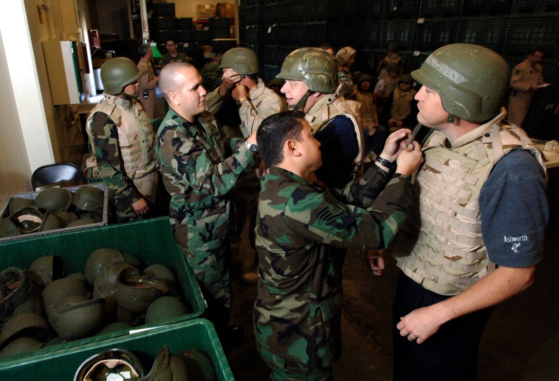 Dan Borges tries on a flak jacket during an honorary commanders' tour June 7 as part of Air Force Week at Travis Air Force Base, Calif. The purpose of Air Force Week is to inform and educate the American public about the importance and roles of the Air Force in America's national defense. (U.S. Air Force photo/Tech. Sgt. Larry A. Simmons)