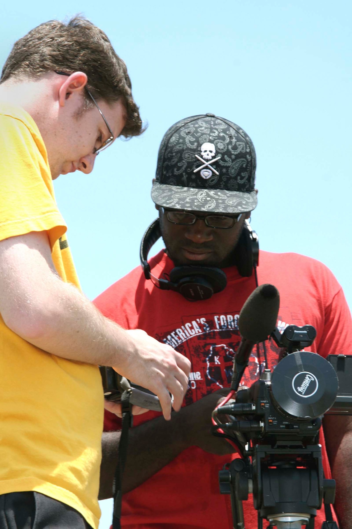 SHAW AIR FORCE BASE, S.C. -- Music Television crew members, Ki Whelan (left) and Jerry Henry setup their camera equipment for an unexploded ordnance disposal drill at Poinsett Range June 8. The MTV crew is shooting footage of Senior Airman Kiel Anderson, 20th Civil Engineer Squadron explosive ordnance disposal technician, for the upcoming season of ''Engaged and Underage," a show which documents young people and life changing experiences.  (U.S. Air Force photo/ Airman Michael Cowley)