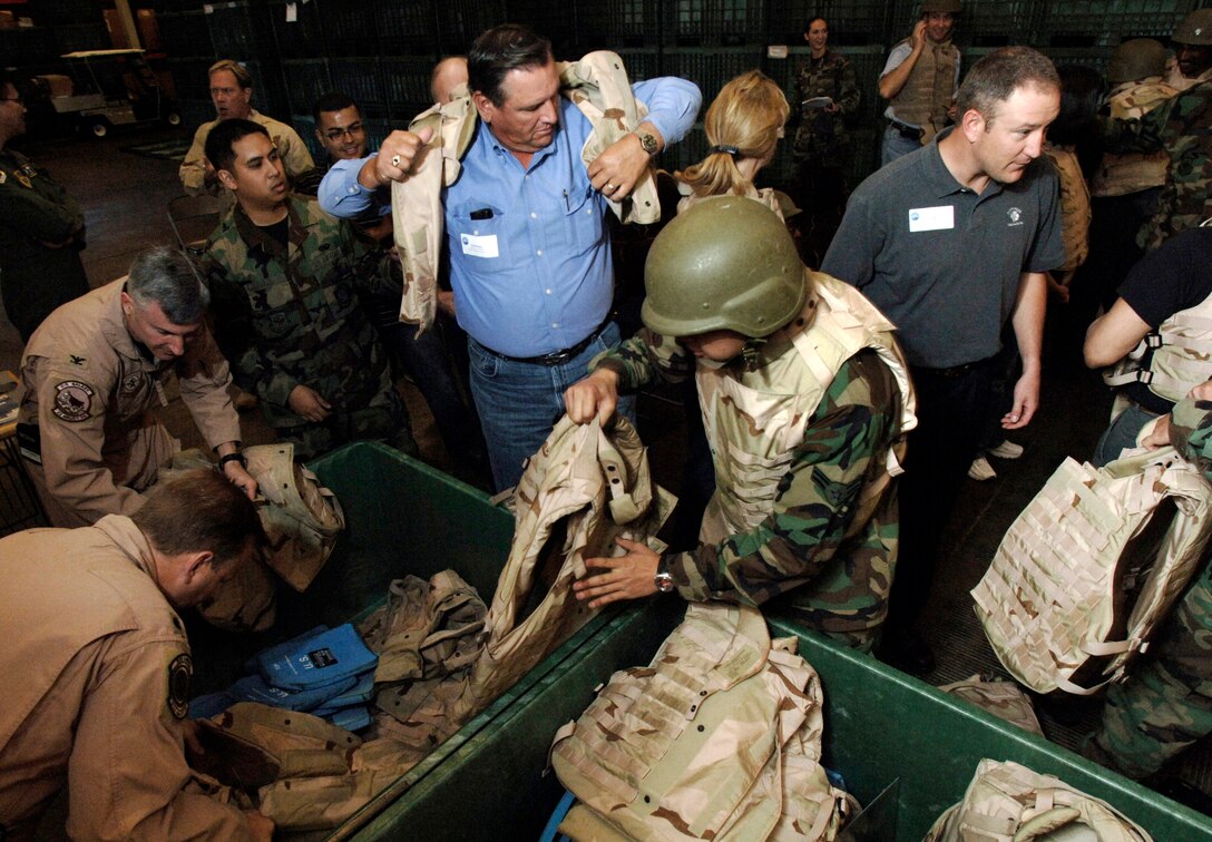 Dan Borges tries on a flak jacket during an honorary commanders' tour June 7 as part of Air Force Week at Travis Air Force Base, Calif. The purpose of Air Force Week is to inform and educate the American public about the importance and roles of the Air Force in America's national defense. (U.S. Air Force photo/Tech. Sgt. Larry A. Simmons)