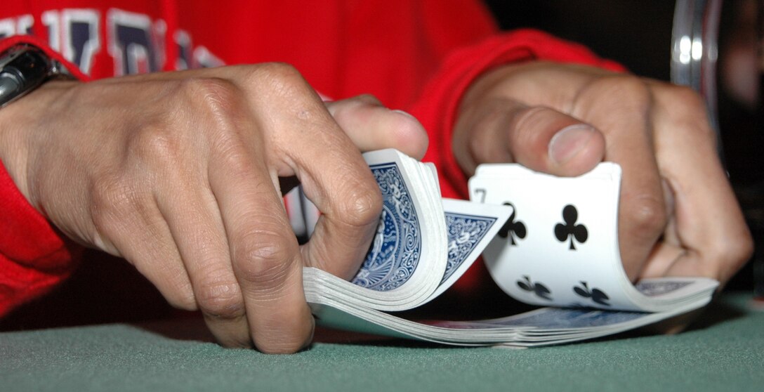 An Ellsworth member shuffles cards during a round of Texas Hold’ em June 8 at the Dakota’s. (U.S. Air Force photo/Tech. Sgt. Todd Wivell)
