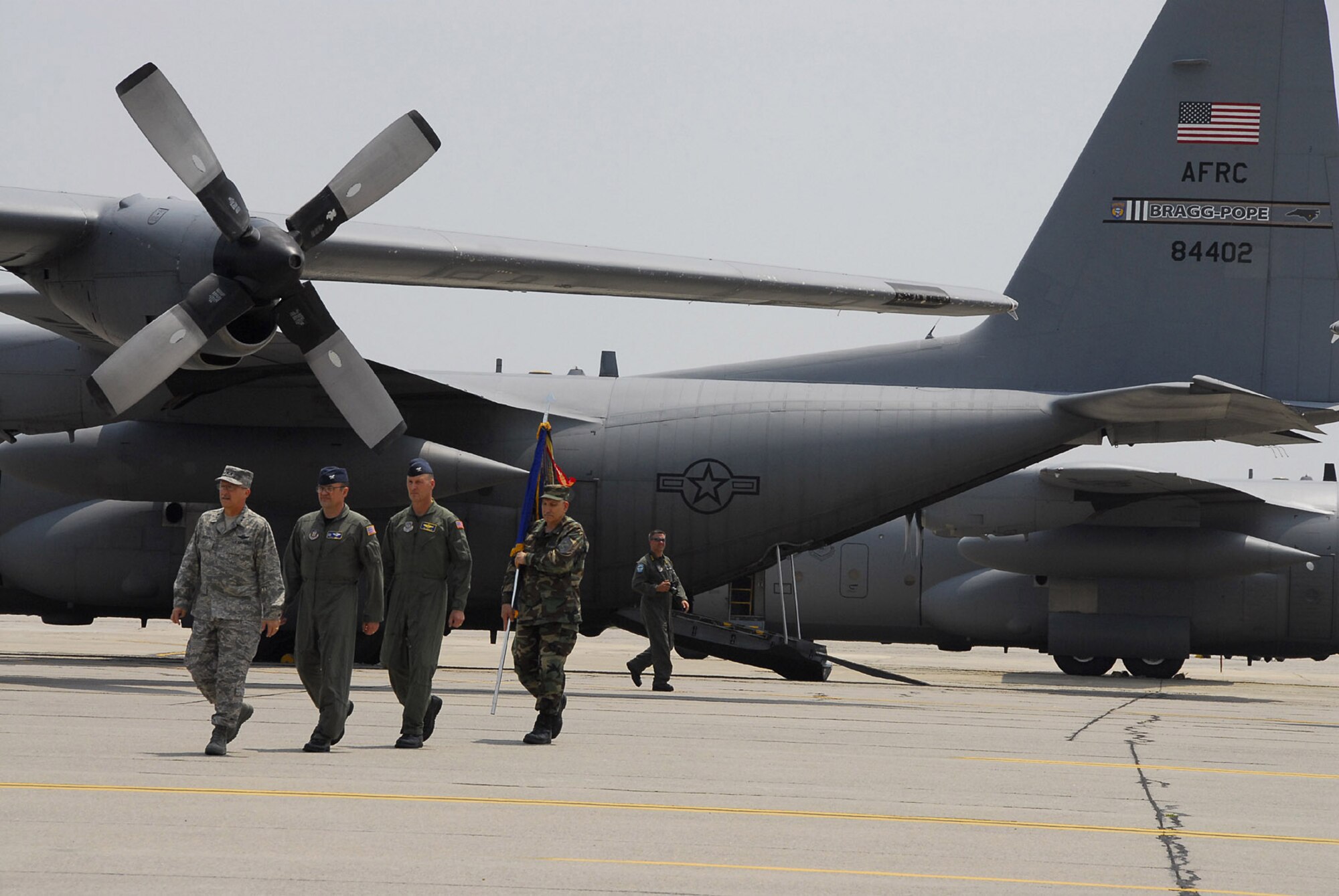 (From left) Col. Merle D. Hart, 440th Airlift Wing commander; Col. Timothy Zadalis, 43rd AW commander; and Chief Master Sgt. Carmon Francher, 440th AW command chief master sergeant, follow Maj. Gen. Martin M. Mazick, 22nd Air Force commander, to the 440th AW?s relocation ceremony upon landing at Pope Air Force Base, N.C. on June 10, 2007. (U.S. Air Force photo/Joe Oliva)