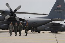 (From left) Col. Merle D. Hart, 440th Airlift Wing commander; Col. Timothy Zadalis, 43rd AW commander; and Chief Master Sgt. Carmon Francher, 440th AW command chief master sergeant, follow Maj. Gen. Martin M. Mazick, 22nd Air Force commander, to the 440th AW?s relocation ceremony upon landing at Pope Air Force Base, N.C. on June 10, 2007. (U.S. Air Force photo/Joe Oliva)