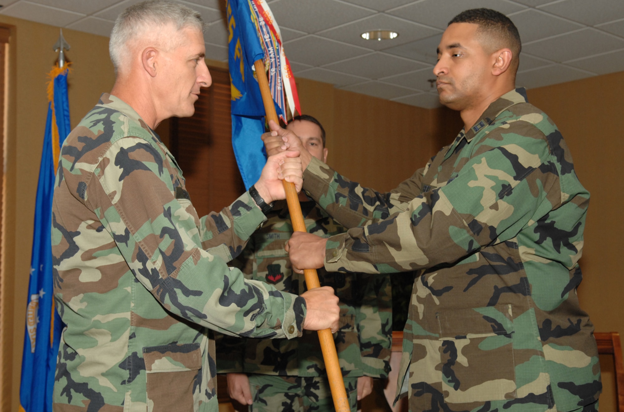 DAVIS-MONTHAN AIR FORCE BASE, Ariz. -- Capt. Jerime L. Reid (right) receives the 355th Services Squadron guidon from 355th Missions Support Group Commander Col. Hal Hoxie at a change-of-command ceremony here June 8.  (U.S. Air Force photo/Senior Airman Jacqueline Hawkins)