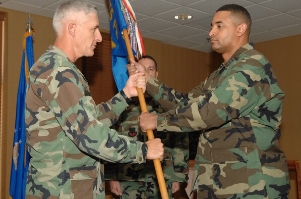 DAVIS-MONTHAN AIR FORCE BASE, Ariz. -- Capt. Jerime L. Reid (right) receives the 355th Services Squadron guidon from 355th Missions Support Group Commander Col. Hal Hoxie at a change-of-command ceremony here June 8.  (U.S. Air Force photo/Senior Airman Jacqueline Hawkins)