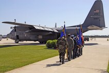 Col. Merle D. Hart, 440th Airlift Wing commander, and Chief Master Sgt. Carmon Francher, wing command chief master sergeant, follow the honor guard to a C-130 during the unit's relocation ceremony June 9, 2007, at Gen. Mitchell International Airport Air Reserve Station in Milwaukee. The motto on the wing flag is Nunquam Non Paratus ? ?Never unprepared." (U.S. Air Force photo/Joe Oliva)