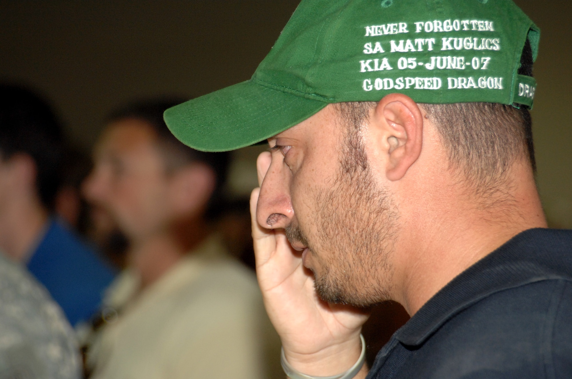 Special Agent Ryan salutes during a memorial ceremony June 8 honoring Special Agents Tech. Sgt. Ryan Balmer and Staff Sgt. Matthew Kuglics at Kirkuk Regional Air Base, Iraq. The agents were killed in action June 5 while supporting Operation Iraqi Freedom. Agent Ryan's hat is embroidered in tribute to his lost friend, Agent Kuglics. (U.S. Air Force photo/ Senior Airman Kristin Ruleau)