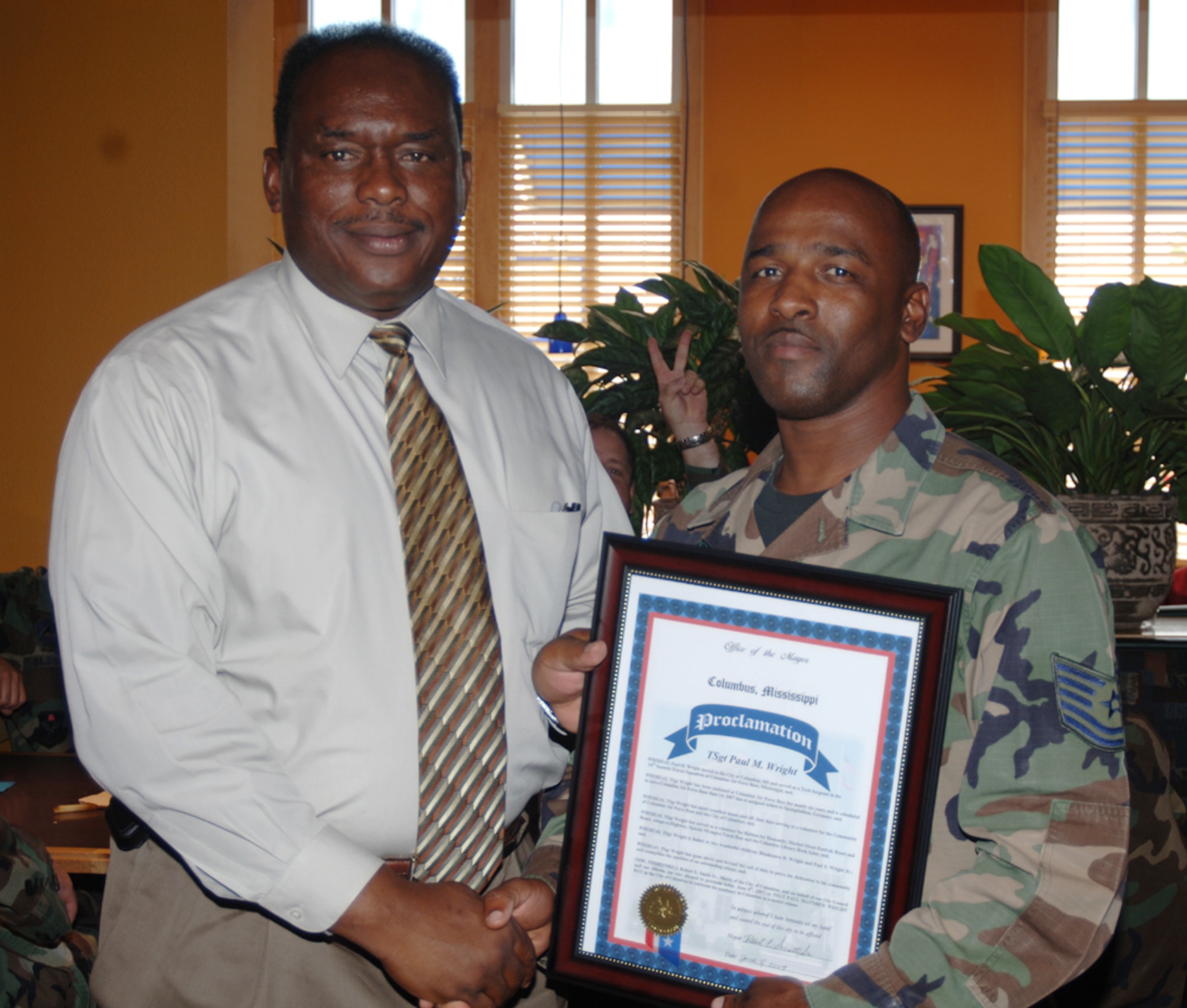 Technical Sgt. Paul Wright, 14th Security Forces Squadron, receives a proclamation from the Honorable Robert Smith, Columbus Mayor, Friday at a luncheon at the Grill. Sergeant Wright was honored for his volunteer work both in the community and at CAFB. (U.S. Air Force Photo by Airman 1st Class Danielle Powell)