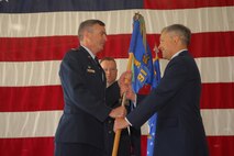 MINOT AIR FORCE BASE, N.D. -- Col. Robert Critchlow (right), the new 91st Operations Group commander, takes the guidon from Col. Marty Whelan, 91st Space Wing commander, during the 91st OG change of command ceremony at the 54th Helicopter Squadron hangar here June 8. As the operations group commander, Col. Critchlow is responsible for the safe, effective operation and maintenance of 150 Minuteman III intercontinental ballistic missiles from 15 remote missile alert facilities and seven UH-1N aircraft used in support of missile field activities dispersed over 8,500 square miles. (U.S. Air Force photo by Airman 1st Class Sharida Bishop)