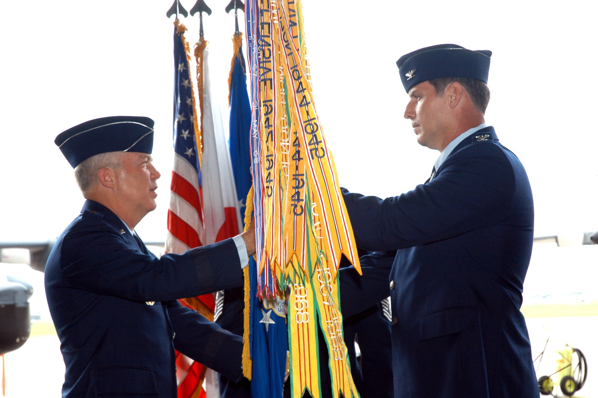 Maj. Gen. Donald Wurster, Air Force Special Operations Command  vice commander, passes the 353rd Special Operations Group guidon to Col. David Mullins, incoming 353rd SOG commander.  The change of command ceremony was held at Kadena June 8.  (USAF photo by Master Sgt. Marilyn C. Holliday)                    