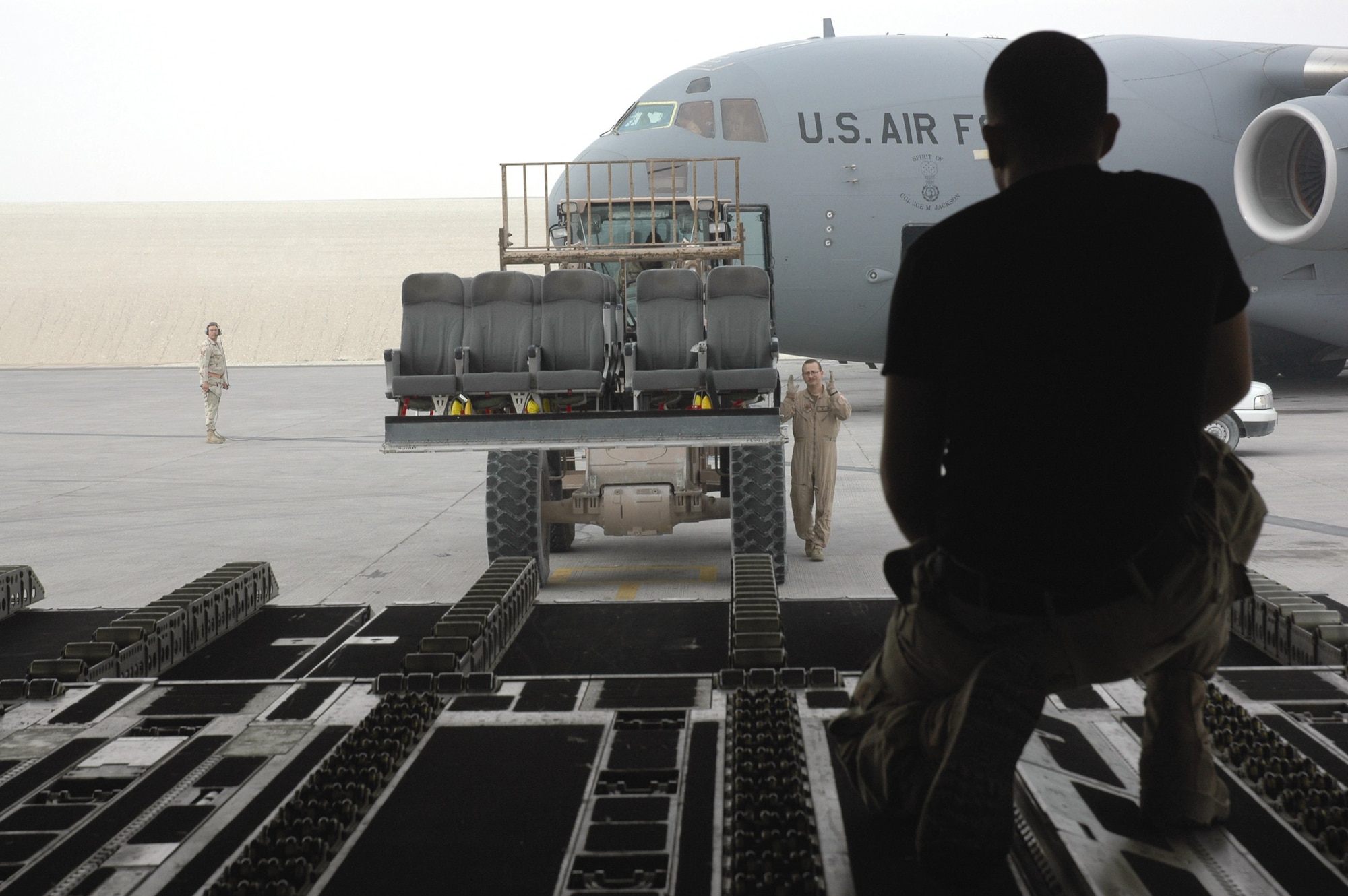 An 816th Expeditionary Airlift Squadron loadmaster oversees cargo being loaded onto a C-17 Globemaster III during Operation Iraqi Freedom (Courtesy photo)
