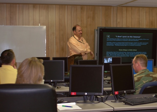Mr. Paige Redfield, Computer Sciences Corporation contractor, AFNetOps A3T, listens to a briefing by the Air Force Network Operations Center senior duty officer, Tuesday, June 5, during mission qualification training for the 917th Communications Flight. (U.S. Air Force photo/Staff Sgt. Ebony Nichols)
