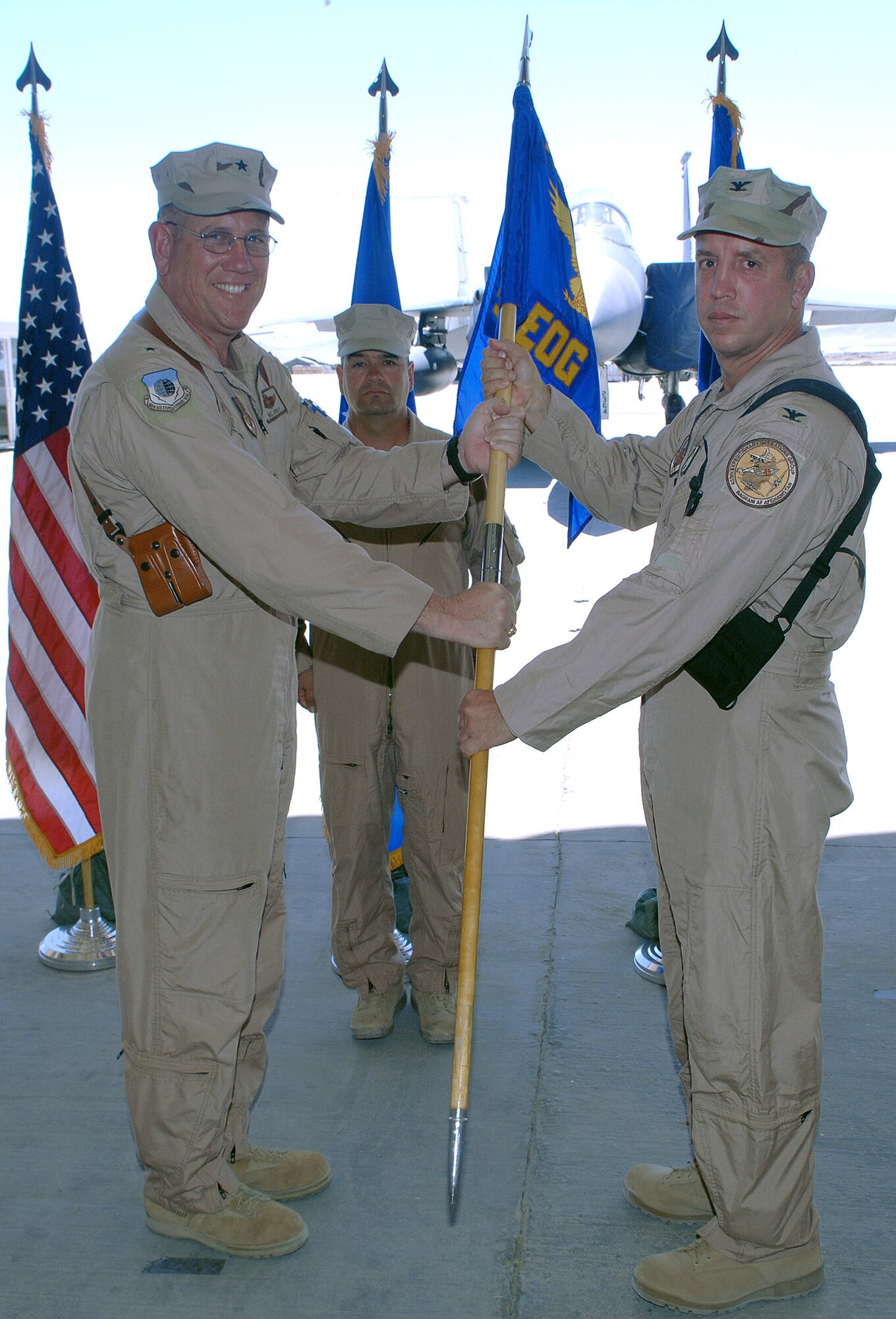 Col. Eric Nelson (right), 455th Operations Group commander, accepts the group's guidon from Brig. Gen. Bill Hyatt, 455th Air Expeditionary Wing commander, signifying the change in command for the group. (photo by Staff Sgt. Craig Seals)