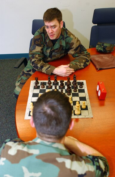 OSAN AIR BASE, Republic of Korea -- Staff Sgt. Robert Keough, 607th Air Intelligence Squadron, teaches another NCO how to play chess here June 8. Sergeant Keough competed at the Armed Forces Chess Tournament June 9-10. (U.S. Air Force photo by Airman 1st Class Jason Epley)