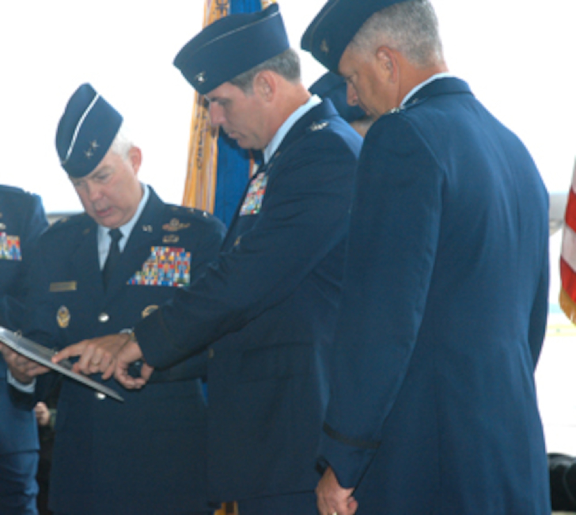 Key players for the 353rd Special Operations Group change of command ceremony look over the script before the event June 8.  From left are:  Maj. Gen. Donald Wurster, Air Force Special Operations Command vice commander; Col. David Mullins, incoming 353rd SOG commander; and Col. Ray Chapman, outgoing commander. The change of command ceremony was held at Kadena Air Base, Japan.     
(U.S. Air Force/Master Sgt. Marilyn Holliday)