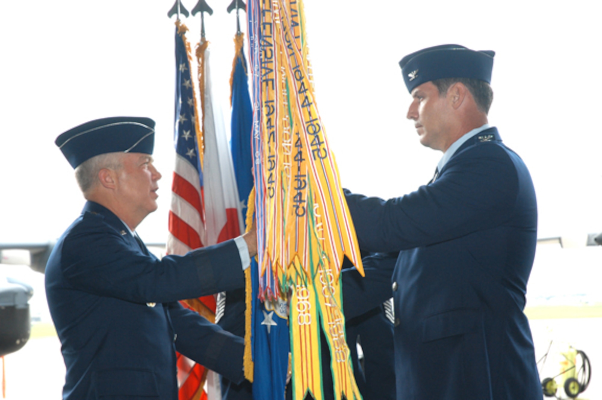 Maj. Gen. Donald Wurster, Air Force Special Operations Command vice commander, passes the 353rd Special Operations Group guidon to Col. David Mullins, incoming 353rd SOG commander, June 8.  The change of command ceremony was held at Kadena Air Base, Japan. 
(U.S. Air Force/Master Sgt. Marilyn Holliday)