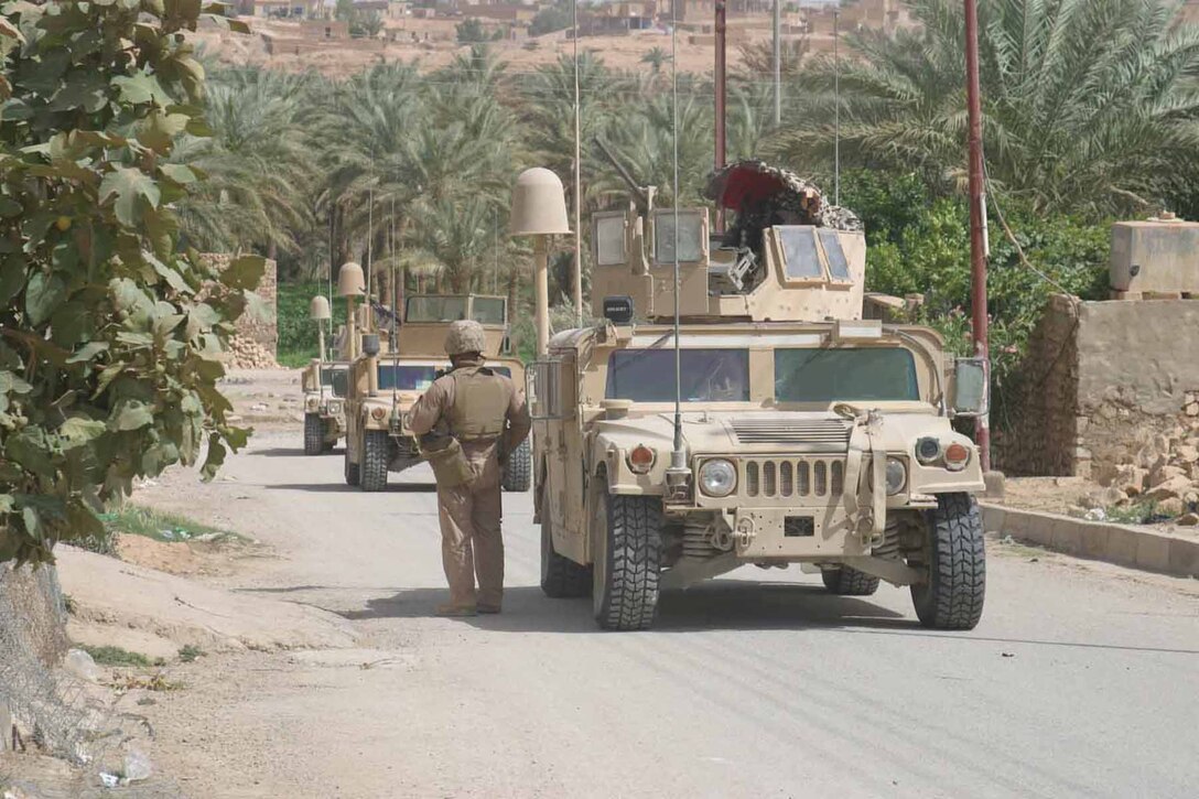 Marines assigned to Mobile Assault Platoon, Charlie Company, 1/3, patrol the city of Haqlaniyah during a mounted patrol, June 12.