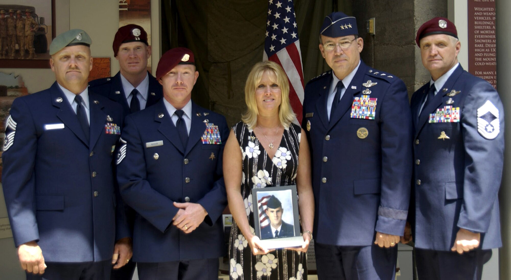 Dawn Peterson (center) holds a portrait of her son, Senior Airman Jason Plite, while standing with Lt. Gen. David A. Deptula who knew Airman Plite. Airman Plite's portrait was part of Arlington National Cemetery's "Faces of the Fallen" exhibit, which featured 1,319 service members who lost their lives after October 2001. In honor of the exhibit's closing June 7, a number of portraits representing each service were turned over directly to surviving family members and representing the Air Force in the ceremony was Airman Plite. (U.S. Air Force photo/Staff Sgt. J.G. Buzanowski) 