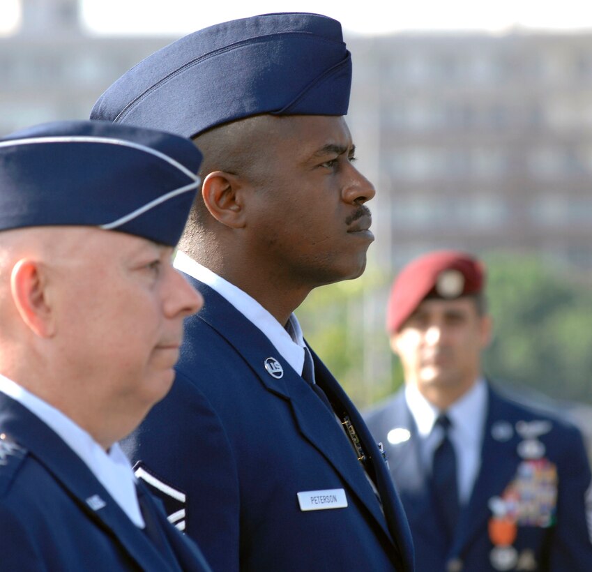 Master Sgt. Charlie Peterson stands beside Air Force Chief of Staff Gen. T. Michael Moseley as the citation to accompany the award is read. The Air Force Combat Action Medal was presented June 12 to six Airmen. They were the first to receive the medal in a ceremony held at the Air Force Memorial in Arlington, Va. (U.S. Air Force photo/Staff Sgt. Brian Ferguson)