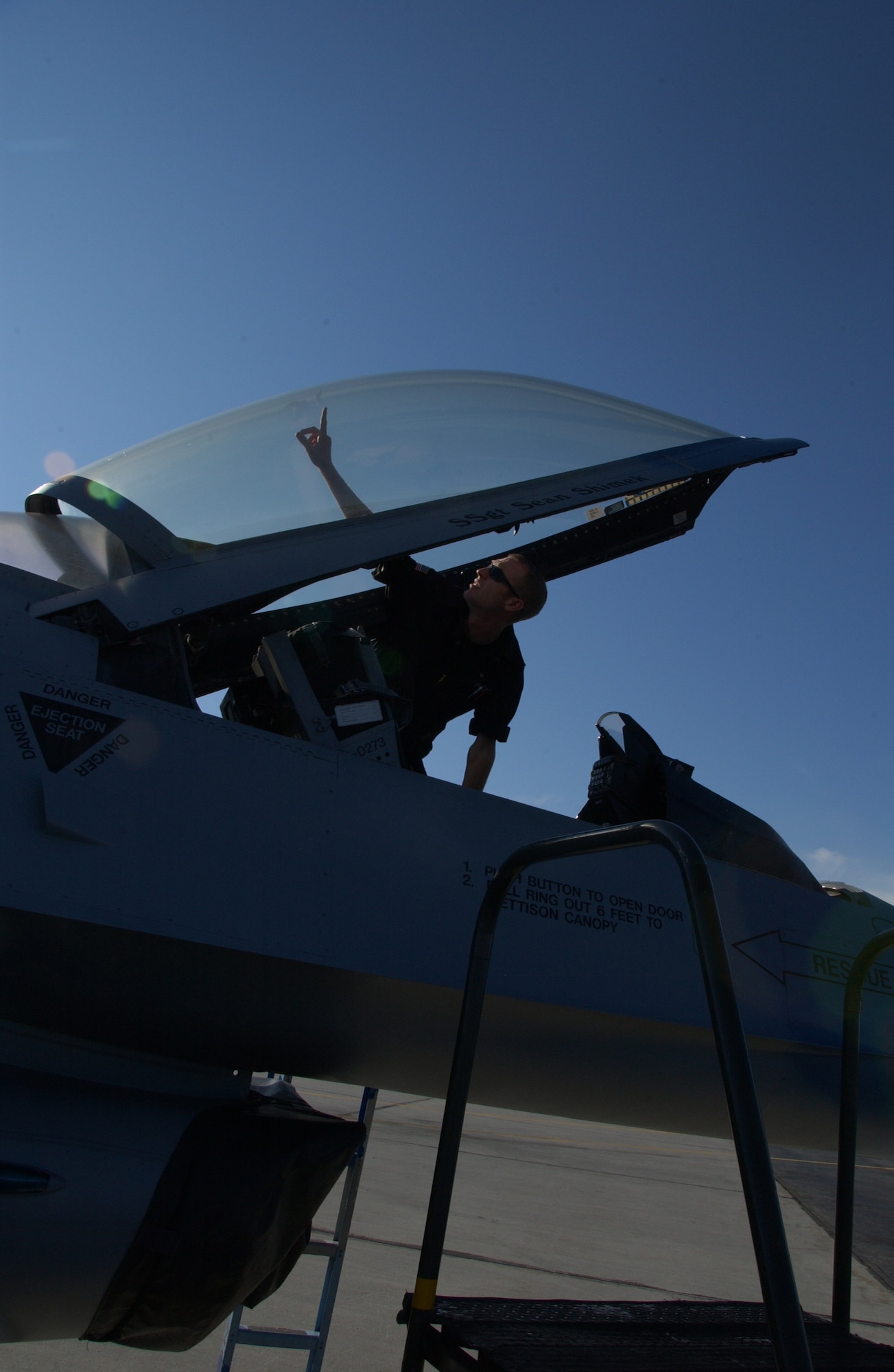 EIELSON AIR FORCE BASE, Alaska --Senior Airman Jed Winkelman, 64th Aggressor Squadron, Nellis Air Force Base, Nev., inspects the canopy of an F-16 to assure it is clean June 8. Airman Winkelman is one of many crew chiefs from around the Air Force who came to participate in Red Flag 07-02, which ends June 15.  (U.S. Air Force photo by Airman 1st Class Christopher Griffin)