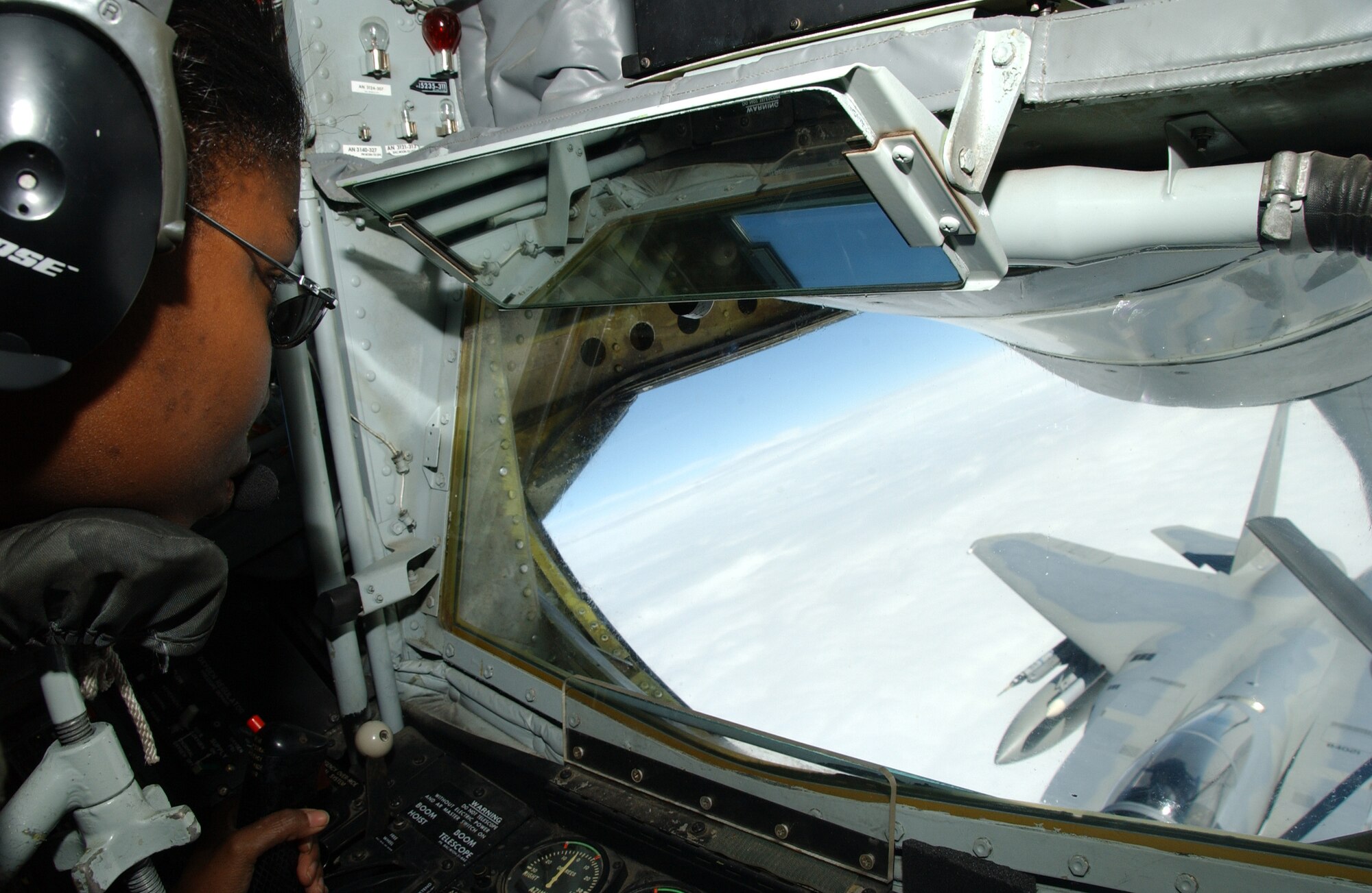 EIELSON AIR FORCE BASE, Alaska -- Senior Airman Kamisha Smith, 912th Air Refueling Squadron, Grand Forks Air Force Base, N.D., refuels a F-15C June 8 in the skies above the Pacific Alaska Range Complex. While fighter pilots are up training during Red Flag 07-02, Airman Smith is up in the air with them to make sure they get the fuel they need to keep things going.  (U.S. Air Force photo by Airman 1st Class Christopher Griffin)