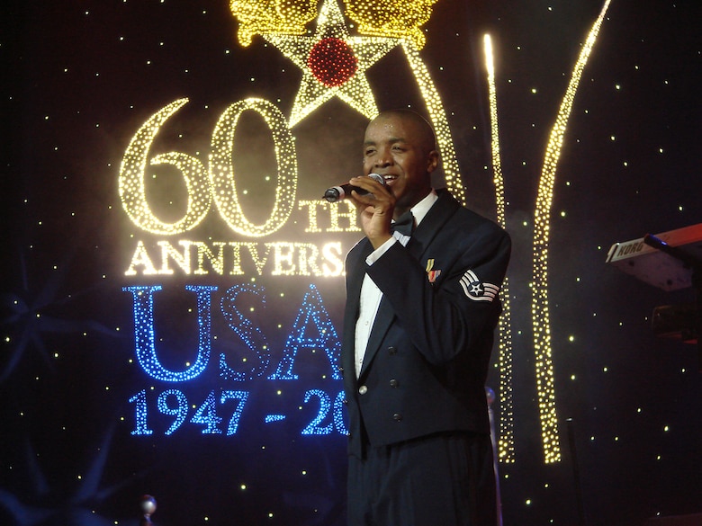 Tops in Blue cast member Staff Sgt. Keith Loudermill performs Hero for Today during the Air Force's signature entertainment group's show in Enid, Okla. Monday. This year's show, called "Flyby," takes the audience on a musical journey of the Air Force from 1947 to the present as it celebrates its 60th anniversary. When not touring, Sergeant Loudermill is a personnel craftsmen with Headquarters Air Force Personnel Center, Randolph AFB, Texas. (U.S. Air Force photo by Frank McIntyre)     