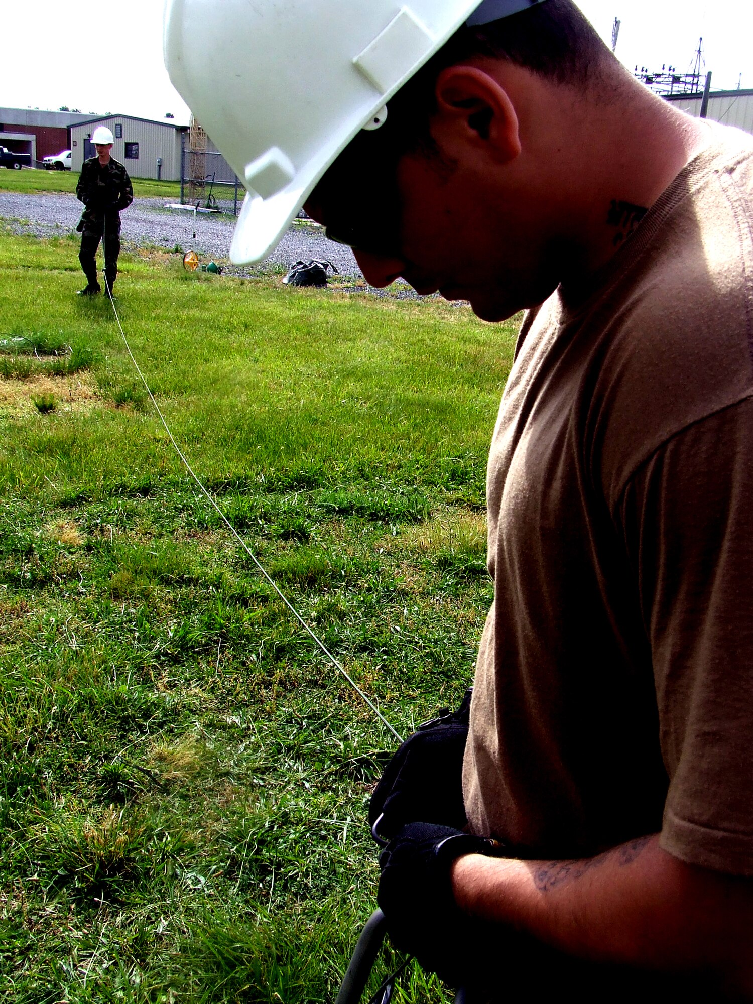 Senior Airman Nick Snowden, 573rd Global Support Squadron, Travis Air Force Base, Calif., prepares stabilization lines along with a fellow student for an antenna pole as part of a class exercise for the Advanced Mobile Command and Control Communications Course at the U.S. Air Force Expeditionary Center June 12, 2007, at Fort Dix, N.J.  The course, taught by the USAF EC's Mobility Operations School, prepares communications Airmen assigned to contingency response units on advanced mobility communications.  (U.S. Air Force Photo/Tech. Sgt. Scott T. Sturkol)