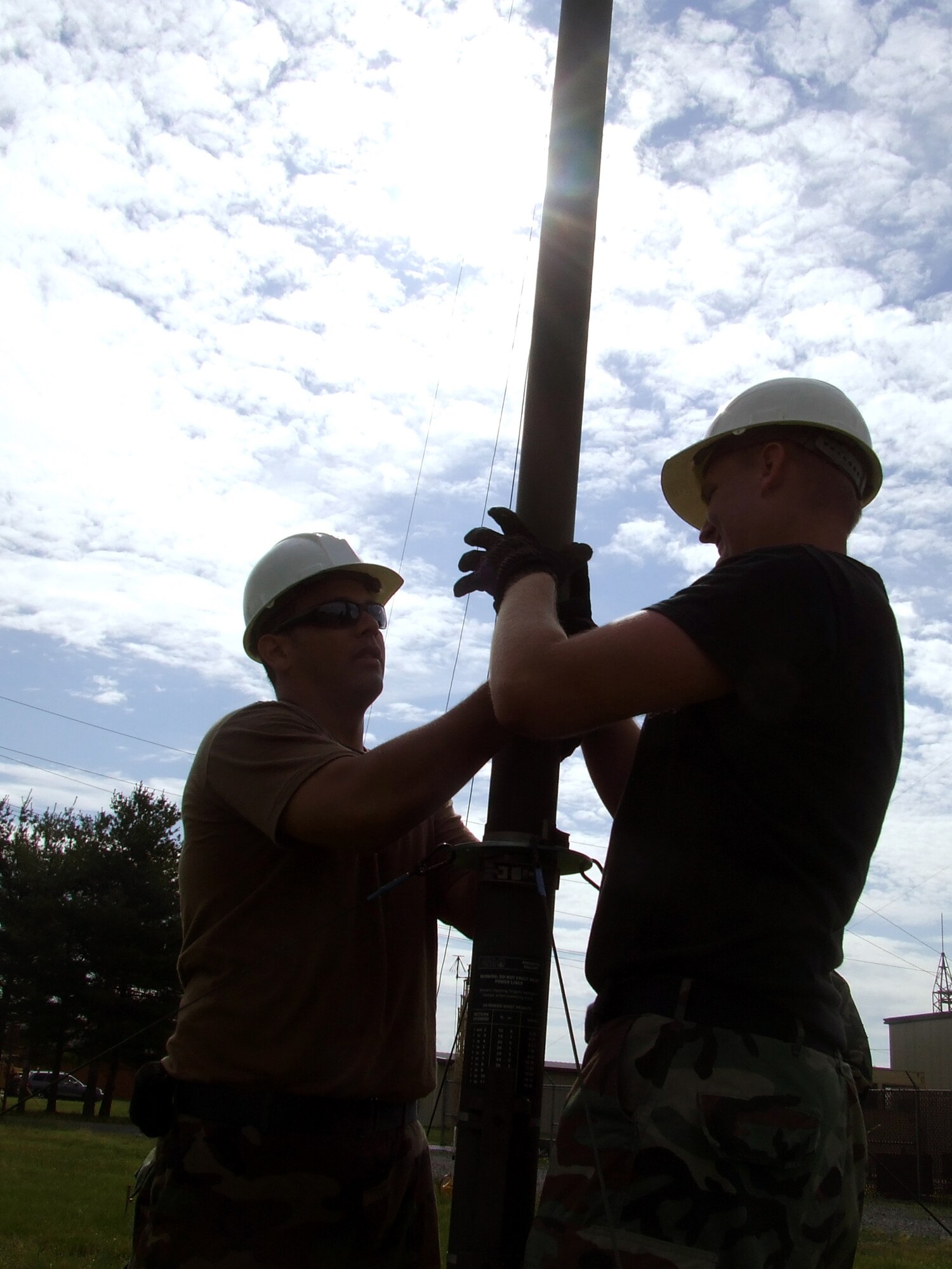 Staff Sgt. Jed Bigleo, 819th Global Support Squadron, McGuire Air Force Base, N.J., and Senior Airman Nick Snowden, 573rd GSS, Travis AFB, Calif., push up an antenna pole as part of a class exercise for the Advanced Mobile Command and Control Communications Course at the U.S. Air Force Expeditionary Center June 12, 2007, at Fort Dix, N.J.  The course, taught by the USAF EC's Mobility Operations School, prepares communications Airmen assigned to contingency response units on advanced mobility communications.  (U.S. Air Force Photo/Tech. Sgt. Scott T. Sturkol)