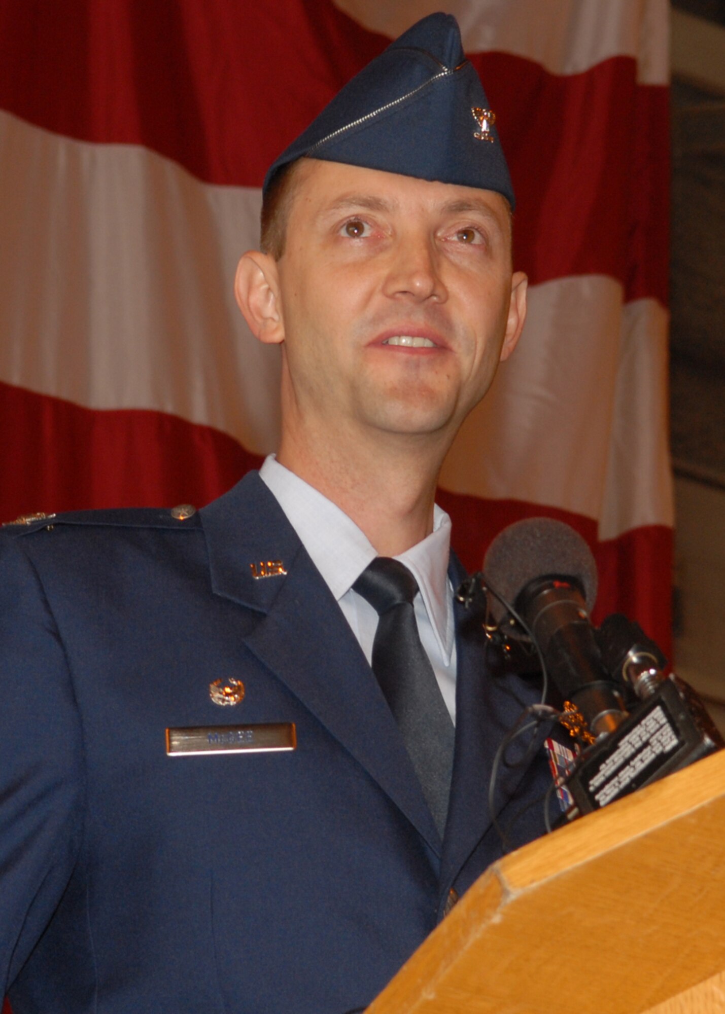 BUCKLEY AIR FORCE BASE, Colo. -- Col. Donald "Wayne" McGee Jr., the new 460th Space Wing commander, addresses Team Buckley, community leaders and guests during a change of command ceremony June 12 at Hangar 909 here. Colonel McGee said he looks forward to the challenging road ahead for the 460th and Team Buckley. (U.S. Air Force photo by Senior Airman LaDonnis Crump)