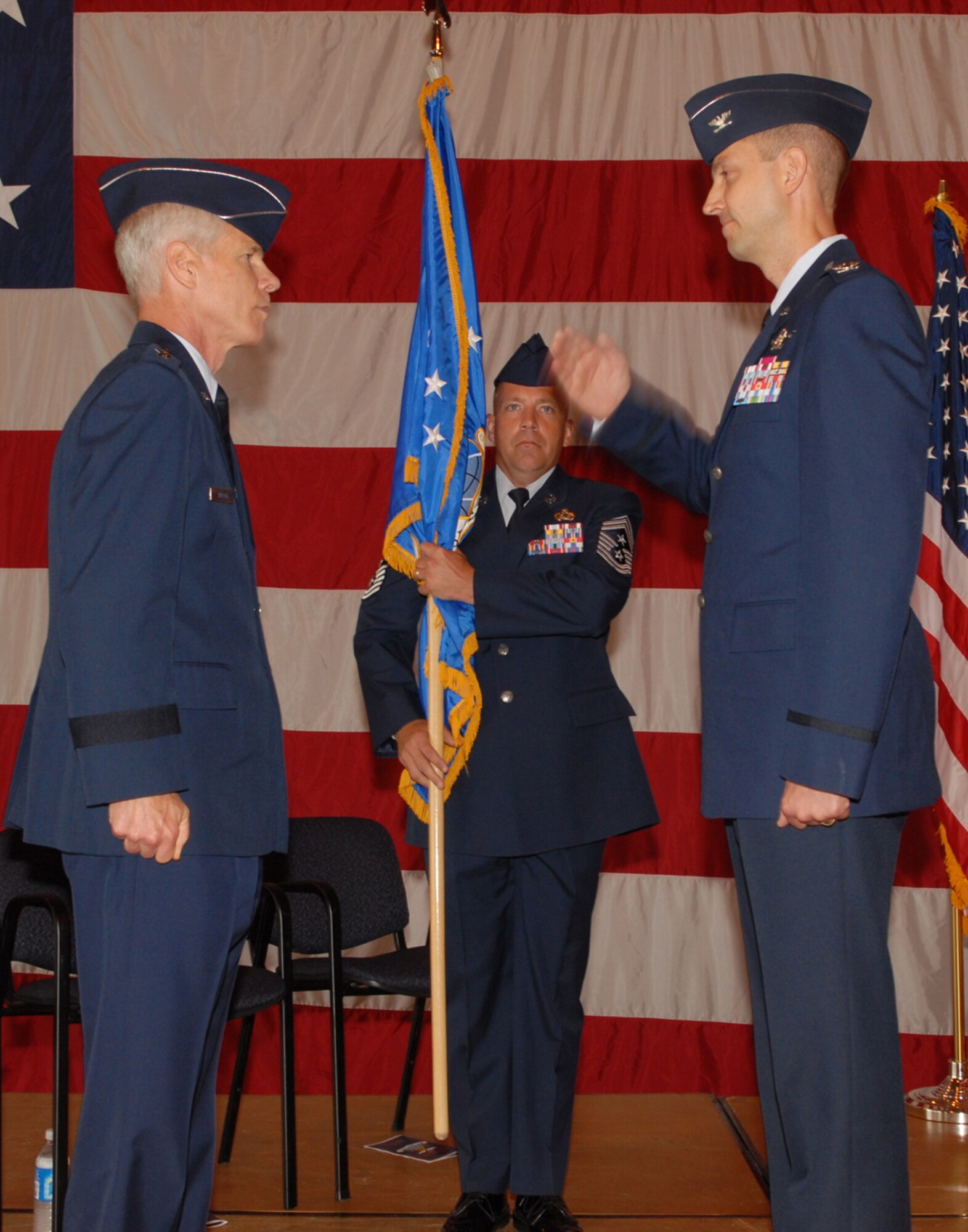 BUCKLEY AIR FORCE BASE, Colo. -- Col. Donald "Wayne" McGee Jr. (right) salutes Maj. Gen. William Shelton (left), 14th Air Force commander, after assuming command of the 460th Space Wing during a change of command ceremony June 12 at Hangar 909 here. Colonel McGee replaced Col. David W. Ziegler who is retiring after 25 years of service. (U.S. Air Force photo by Senior Airman LaDonnis Crump)