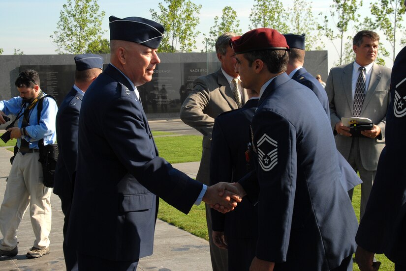 ARLINGTON, Va. -- Chief of Staff of the Air Force Gen. T. Michael Moseley shakes Senior Master Sgt. Ramon Colon-Lopez's hand after the Air Force Combat Medal Ceremony at the Air Force Memorial today.  The medals were presented to six Airmen at the event, and were the first to ever be given out.