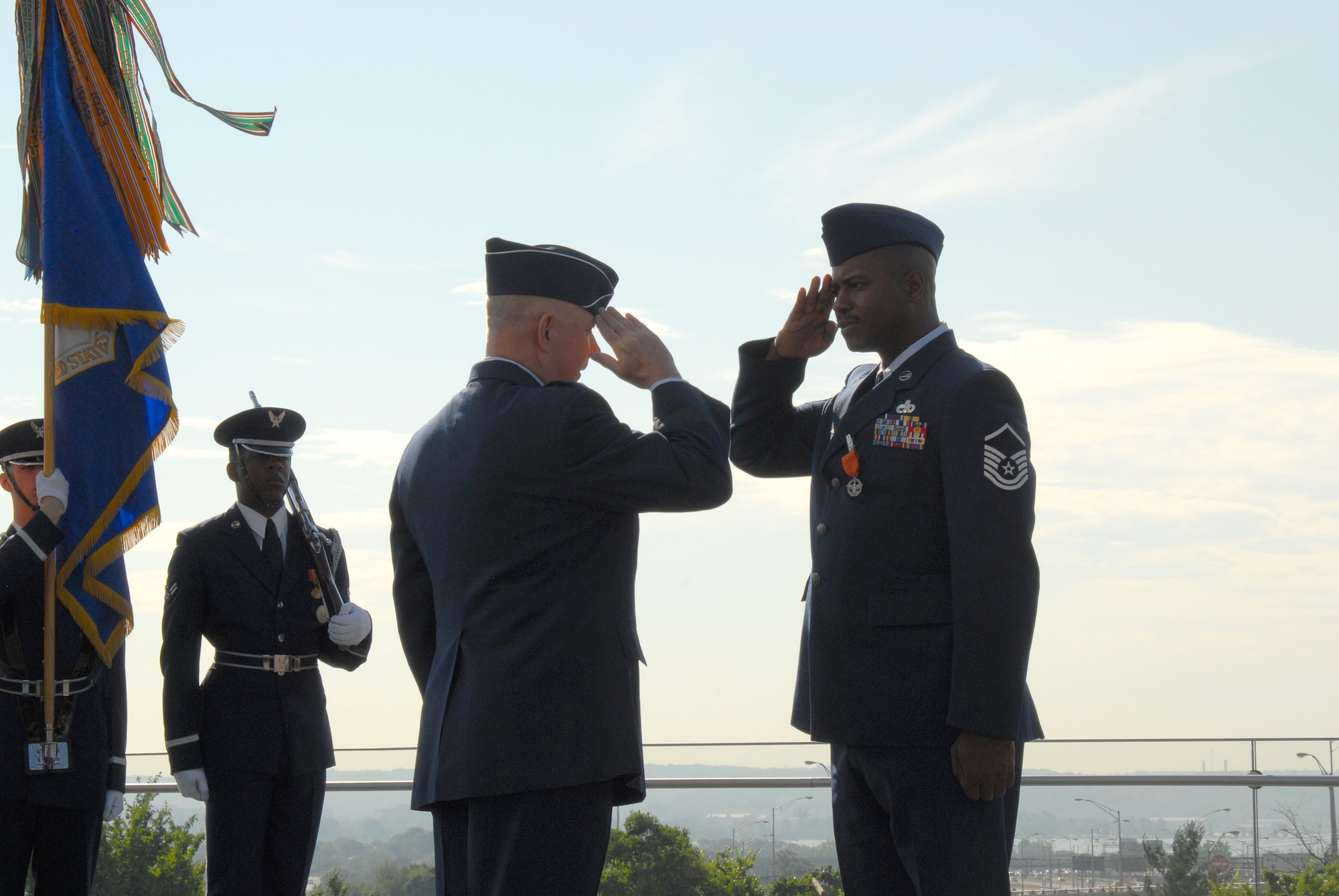 ARLINGTON, Va. -- Chief of Staff of the Air Force Gen. T. Michael Moseley presents the Air Force Combat Action Medal to Master Sgt. Charlie Peterson, who received the medal for heroic actions while deployed on convoy duty in 2004.  The medal was presented for the first time to six Airmen at the ceremony held at the Air Force Memorial today.