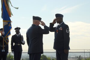 ARLINGTON, Va. -- Chief of Staff of the Air Force Gen. T. Michael Moseley presents the Air Force Combat Action Medal to Master Sgt. Charlie Peterson, who received the medal for heroic actions while deployed on convoy duty in 2004.  The medal was presented for the first time to six Airmen at the ceremony held at the Air Force Memorial today.