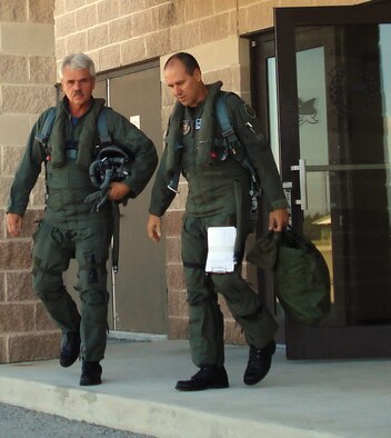 Mr. Robert G. Steele, a painter and illustrator who is a member of the Air Force Artist Program, walks out for a ride in an F-16 at Homestead Air Reserve Base, Fla., June 11, accompanied by Col. Randall G. Falcon, commander of the 482nd Fighter Wing.  Mr. Steele visited the base to learn about the Air Force Reserve and document the activities of Citizen Airmen, their equipment and activities.  For more information about the Air Force Artist Program, visit http://www.afapo.hq.af.mil/Presentation/Content/aboutArt.cfm (U.S. Air Force photo/Jake Shaw
