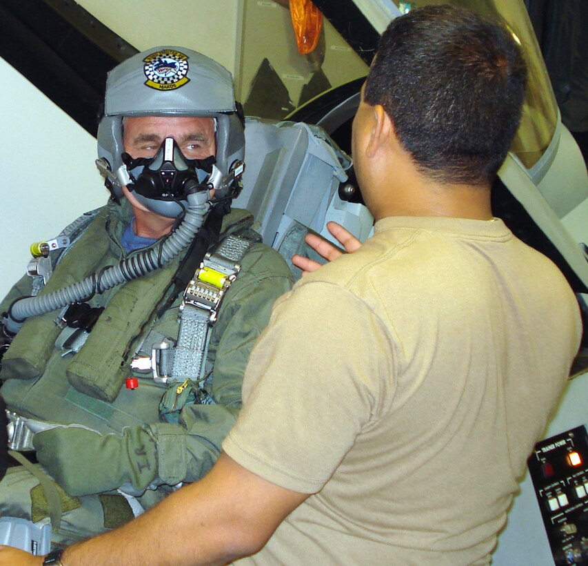 Mr. Robert G. Steele, a painter and illustrator who is a member of the Air Force Artist Program, receives seat training for a backseat ride in an F-16 at Homestead Air Reserve Base, Fla., June 11.  The trainer in the photo is Master Sgt. Jay Colon, a life support specialist with the 93rd Fighter Squadron.  Mr. Steele visited the base to learn about the Air Force Reserve and document the activities of Citizen Airmen, their equipment and activities.  For more information about the Air Force Artist Program, visit http://www.afapo.hq.af.mil/Presentation/Content/aboutArt.cfm (U.S. Air Force photo/Jake Shaw) 