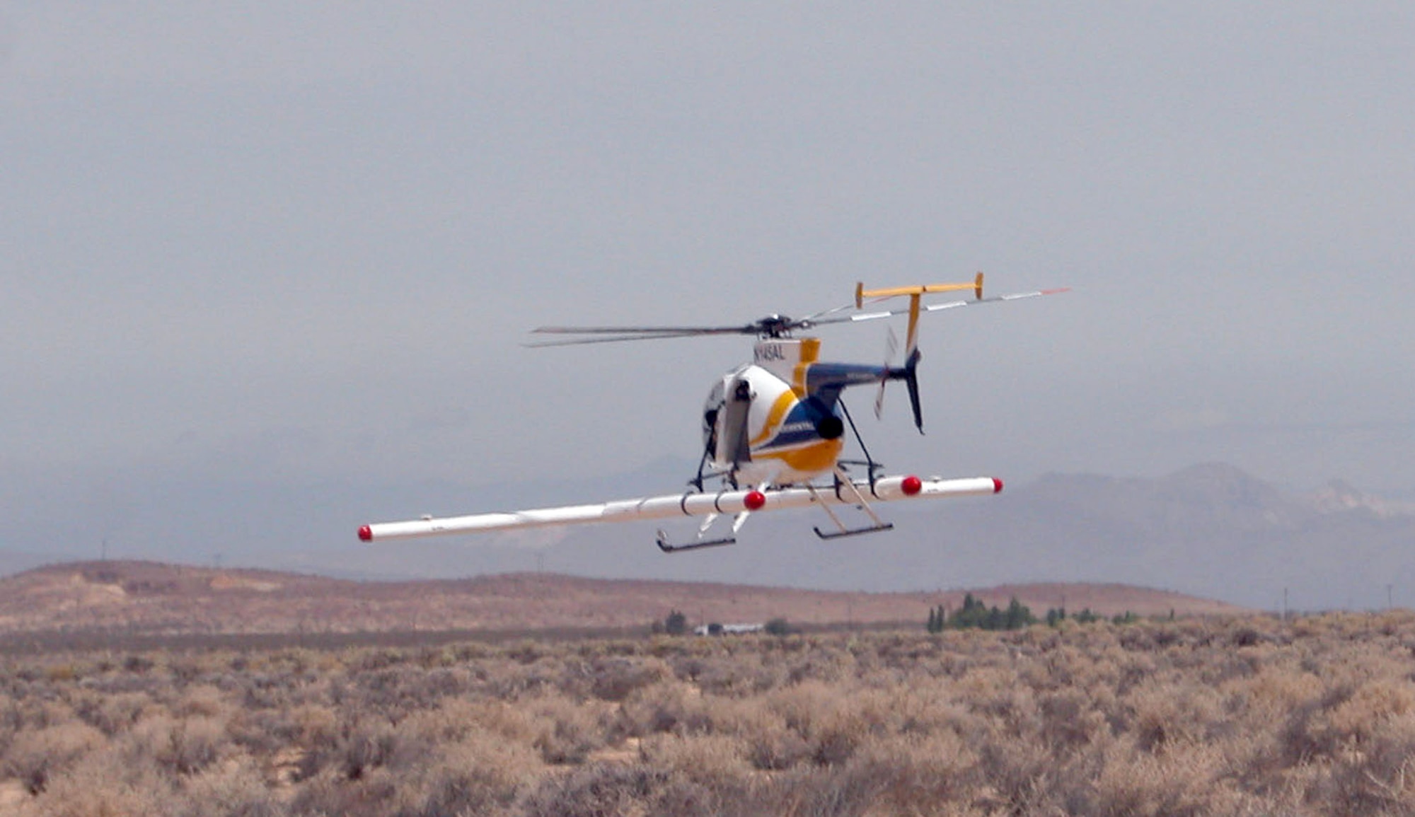 A Hughes 500D helicopter hovers over Edwards' non-operational ranges during a sortie recently. (Photo by Wendelyn Leon)