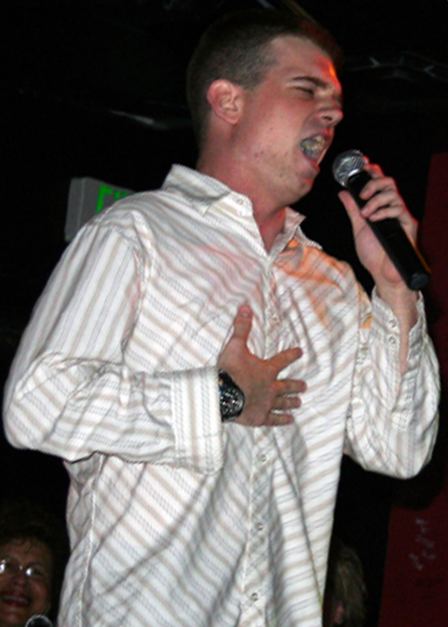 EIELSON AIR FORCE BASE, Alaska--Airman 1st Class Scott Hall, 354th Communications Squadron, of San Antonio, sang Gloria Gaynor's disco anthem "I Will Survive" June 1 at the Yukon Club during finals audition for the Eielson eIeDOL contest. Hall stepped up his performance a notch when he fell to his knees and slid across the dance floor. Hall said if he wins the competition he would like to pursue his dream of singing professionally. (U.S. Air Force photo by Deborah Ward)