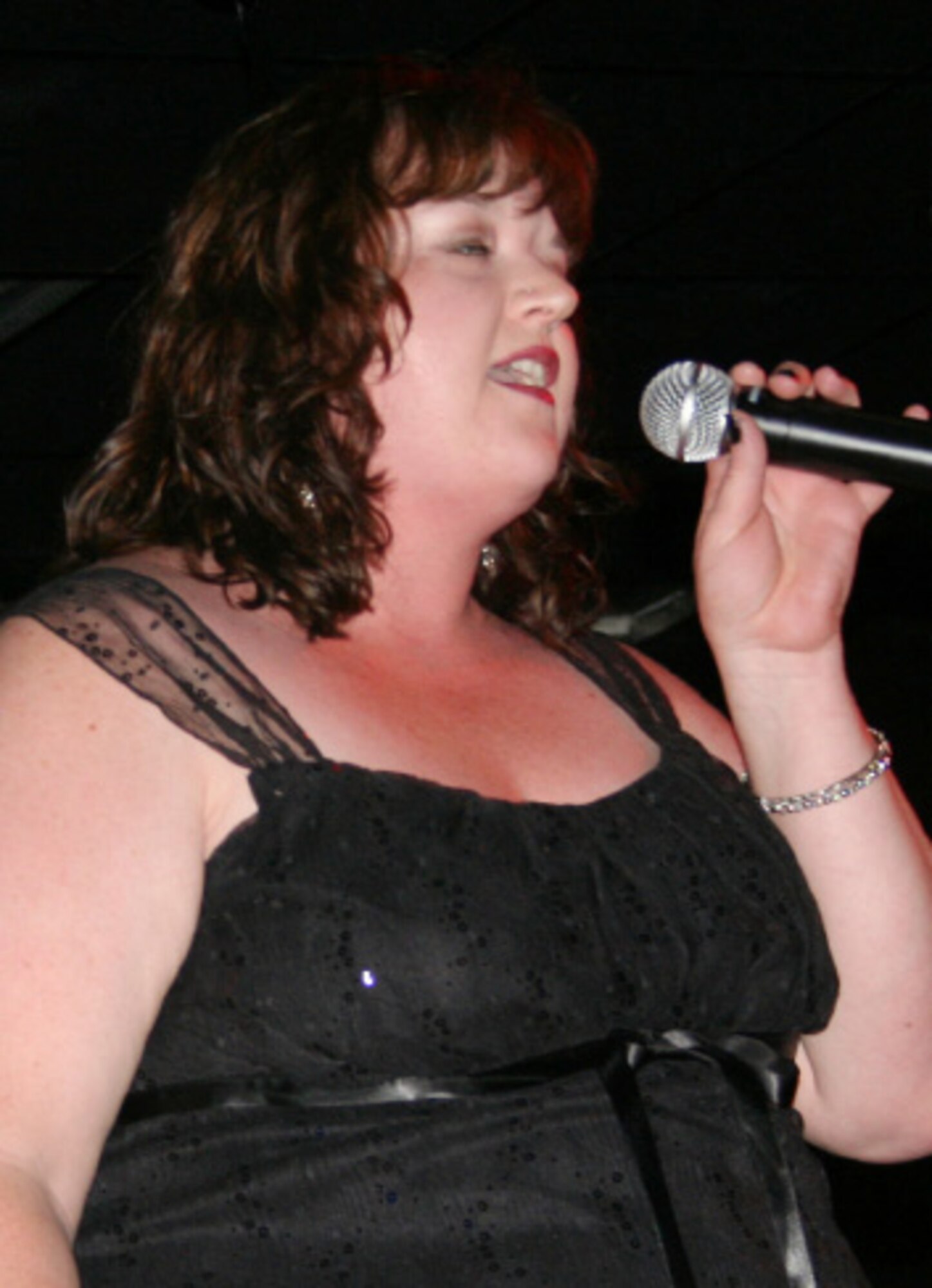 EIELSON AIR FORCE BASE, Alaska--Jodi Grimes of Kearney, Miss., and wife of Staff Sgt. James Grimes, 354th Maintenance Squadron ammunitions, sings "The Night the Lights Went Out in Georgia" June 1 at the Yukon Club during finals audition for the Eielson eIeDOL contest. Jodie is not a new-comer to competitions, at age 15, she won a singing contest in Nashville, Tenn. (U.S. Air Force photo by Deborah Ward)