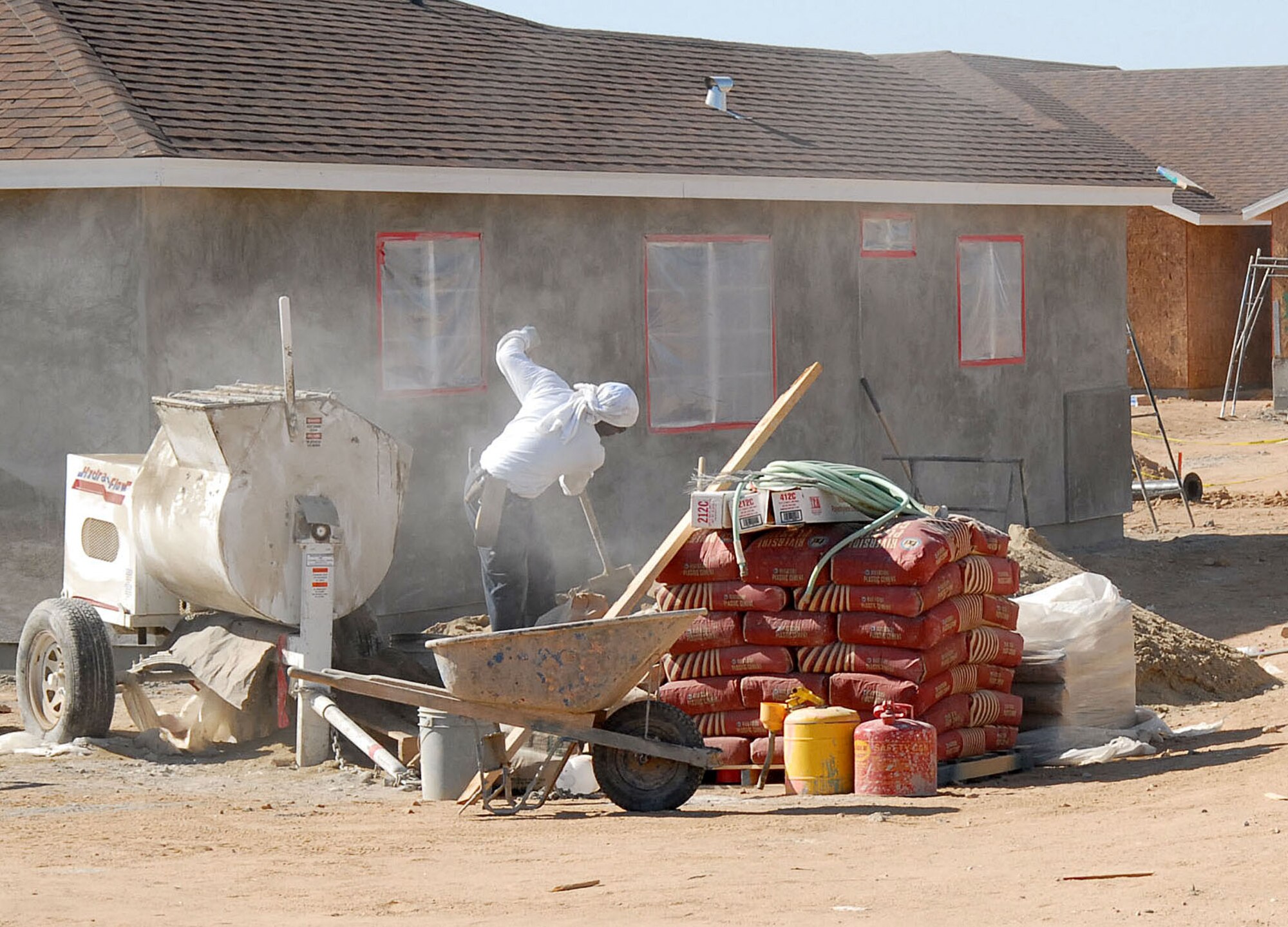 A construction worker prepares cement for Edwards' new housing. (Photo by Senior Airman Jason Hernandez)