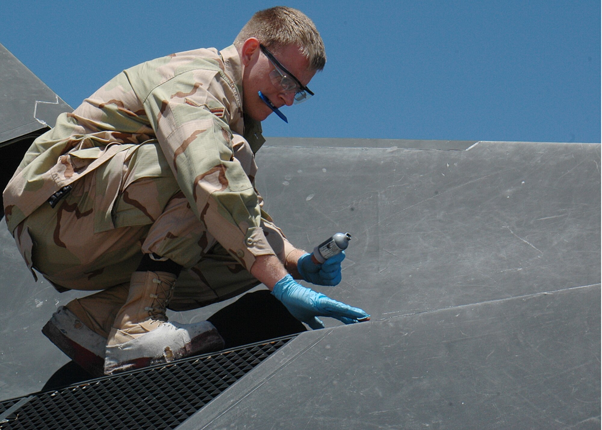 Airman 1st Class Michael Wagner, 49th Maintenance Squadron, puts a special gel on the F-117A after three Nighthawks landed at Cannon Air Force Base, N.M. Twenty five Airmen traveled to Cannon for the Pioneer Air Festival where the team took first place with a weapons load competition and bomb drop demonstration. (U.S. Air Force photo/Airman 1st Class Heather Stanton)