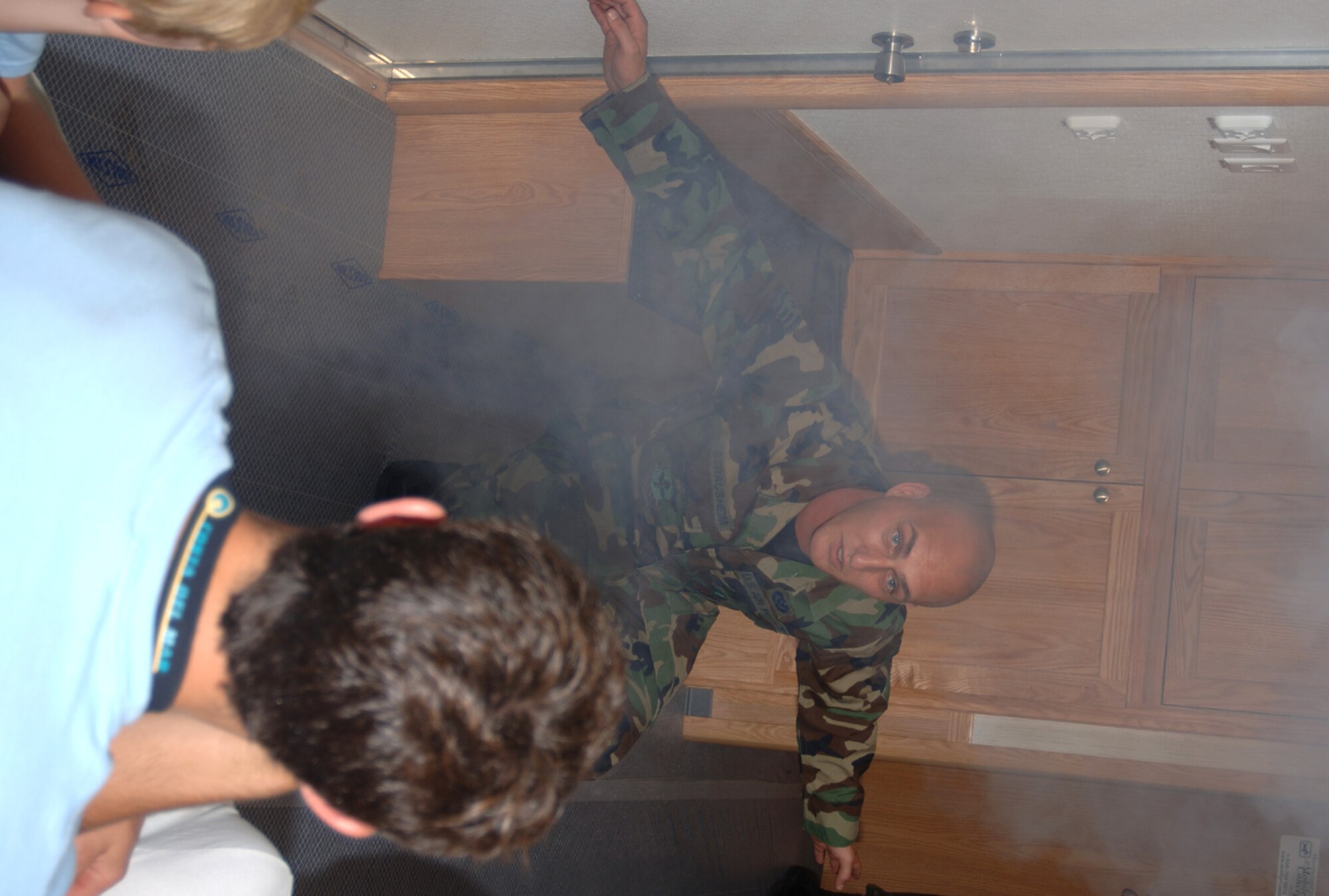 Staff Sgt. Darnell Strauheim, 14th Civil Engineer Squadron, demonstrates fire prevention techniques Friday to a group of youth. CAFB has recently received a Fire Prevention Trailer to educate the BLAZE Team on the best ways to react during a houshold fire. (U.S. Air Force Photo by Airman 1st Class Danielle Powell)