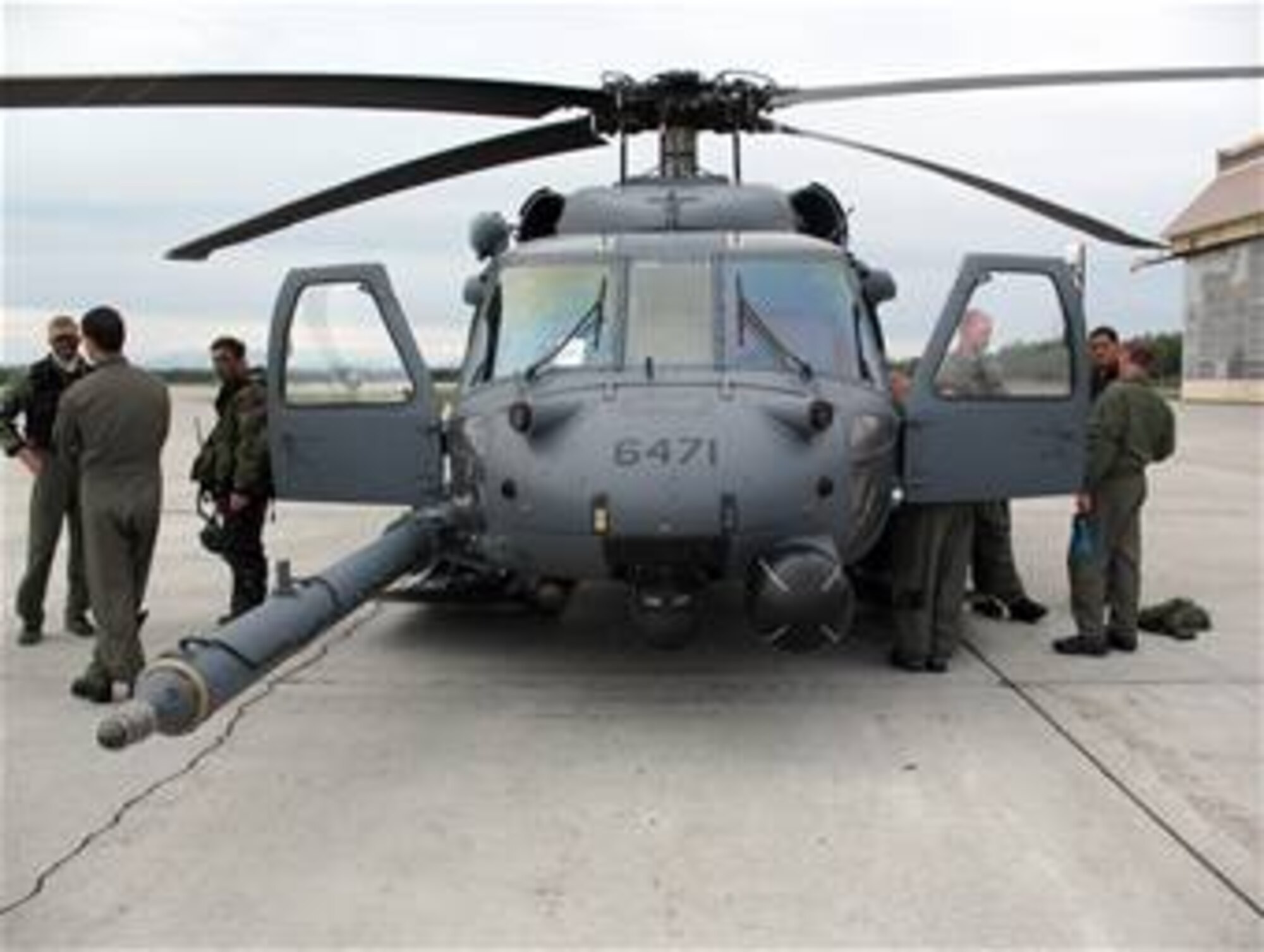 Aircrew members and pararescuemen from the Alaska Air National Guard's 210th and 212th rescue squadrons stand near an HH-60 Pave Hawk June 10 after completing a successful search and rescue exercise during Red Flag-Alaska. The teams work together with survival, evasion, resistance and escape specialists to rehearse scenarios for rescuing pilots shot down during combat. (U.S. Navy photo/Petty Officer A.C. Rainey)