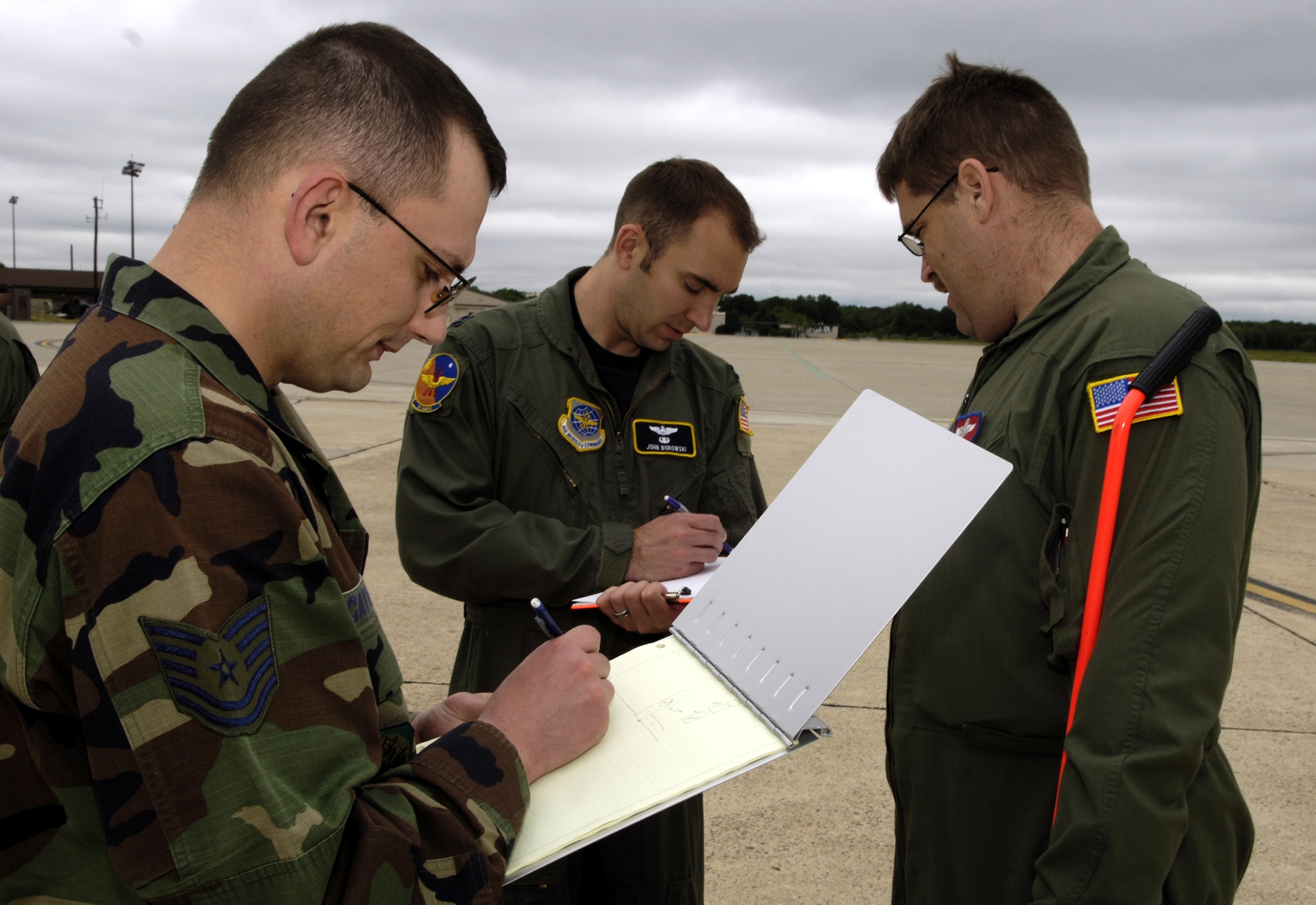 Students in the Mobility Air Forces Mobile Command and Control Leadership Course record information as part of an airfield survey exercise for the course June 4, 2007, on the McGuire Air Force Base, N.J., flightline.  The course, taught by the U.S. Air Force Expeditionary Center's Mobliity Operations School at Fort Dix, N.J., teaches Airmen, officer and enlisted, to become better leaders as contingency response element commanders or contingency response team chiefs.  (U.S. Air Force Photo/Ken Mann)