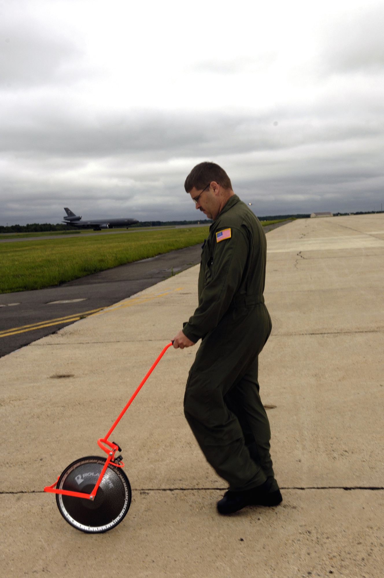 Master Sgt. Michael Deehr, 819th Global Support Squadron, McGuire Air Force Base, N.J., uses a measuring wheel while participating in an airfield survey exercise for the Mobility Air Forces Mobile Command and Control Leadership Course June 4, 2007, on the McGuire flightline.  The course, taught by the U.S. Air Force Expeditionary Center's Mobliity Operations School at Fort Dix, N.J., teaches Airmen, officer and enlisted, to become better leaders as contingency response element commanders or contingency response team chiefs.  (U.S. Air Force Photo/Ken Mann)