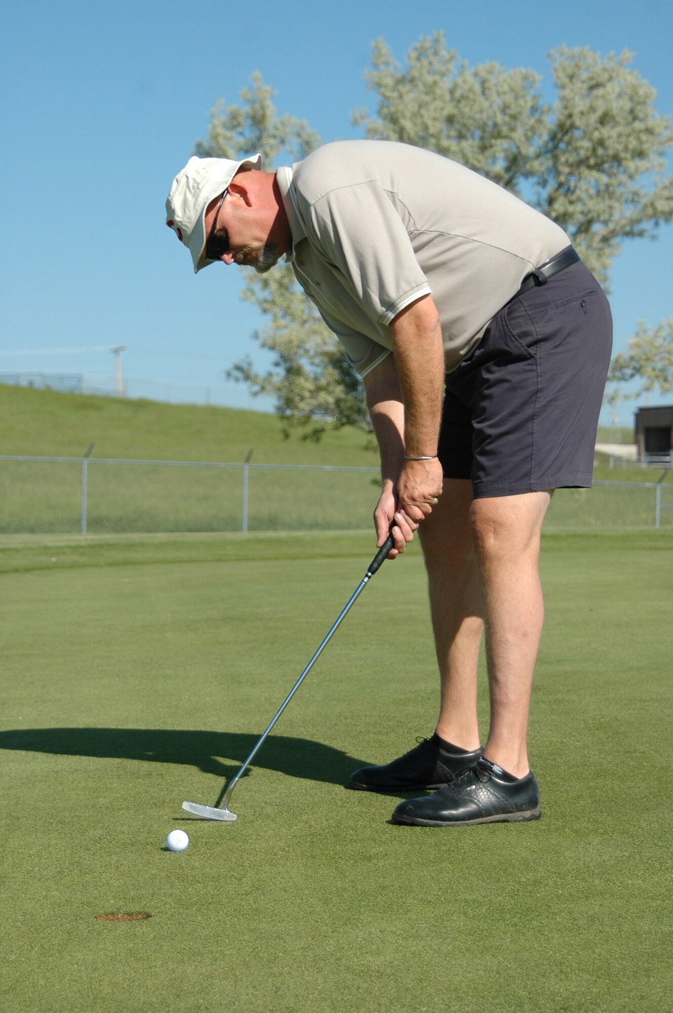 Bernie Altergott sinks his 4-foot putt on the par-4 6th hole of the Prairie Ridge Golf course during the two-person tournament June 9. Bernie and his wife, Suzanne, took 2nd place in the tournament. The two-person tournament used the Ryder Cup format. All teams played six holes as a scramble, six holes using best ball and six holes using alternate shots. “The tournament was a great success,” said Jerry Gullion, Prairie Ridge Golf course assistant manager, “We had a super time and will do continue to do this annually.” (U.S. Air Force photo/Tech. Sgt. Todd Wivell)