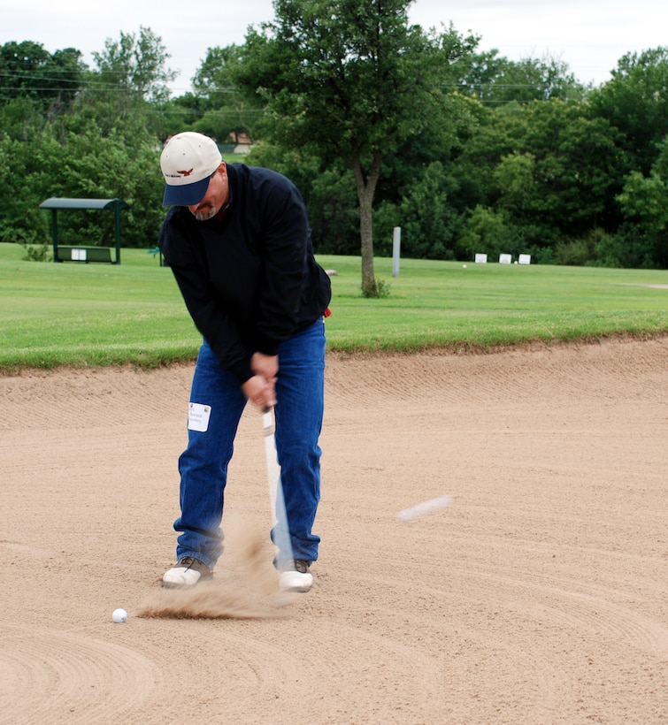 Howard Roitenberg, a representative from Pratty and Whitney, hits his ball out of the sand-trap during the 37th Annual Board of Commerce and Industry/Sheppard Air Force Base Golf Tournament June 8 at Wind Creek Golf Course. (U.S. Air Force photo/Airman 1st Class Jacob Corbin)