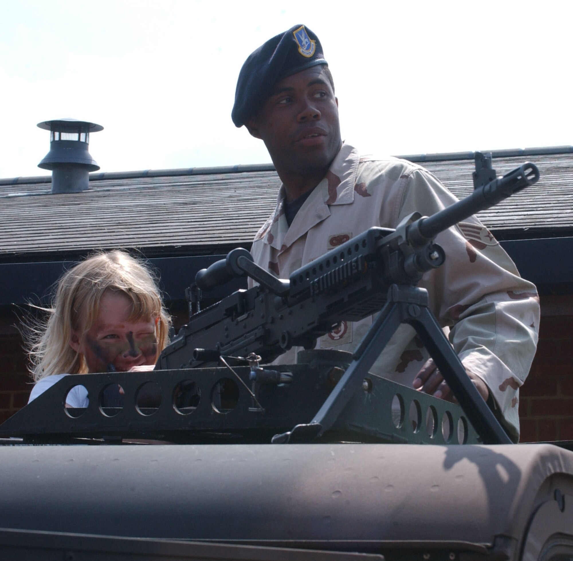 Senior Airman Damian Lee gives 9-year-old Emily Wilson a preview of a humvee during the Operation Together & Ready activicty held at the child development center at RAF Mildenhall June 9, 2007. (U.S Air Force photo by Airman Brad Smith)                                     
