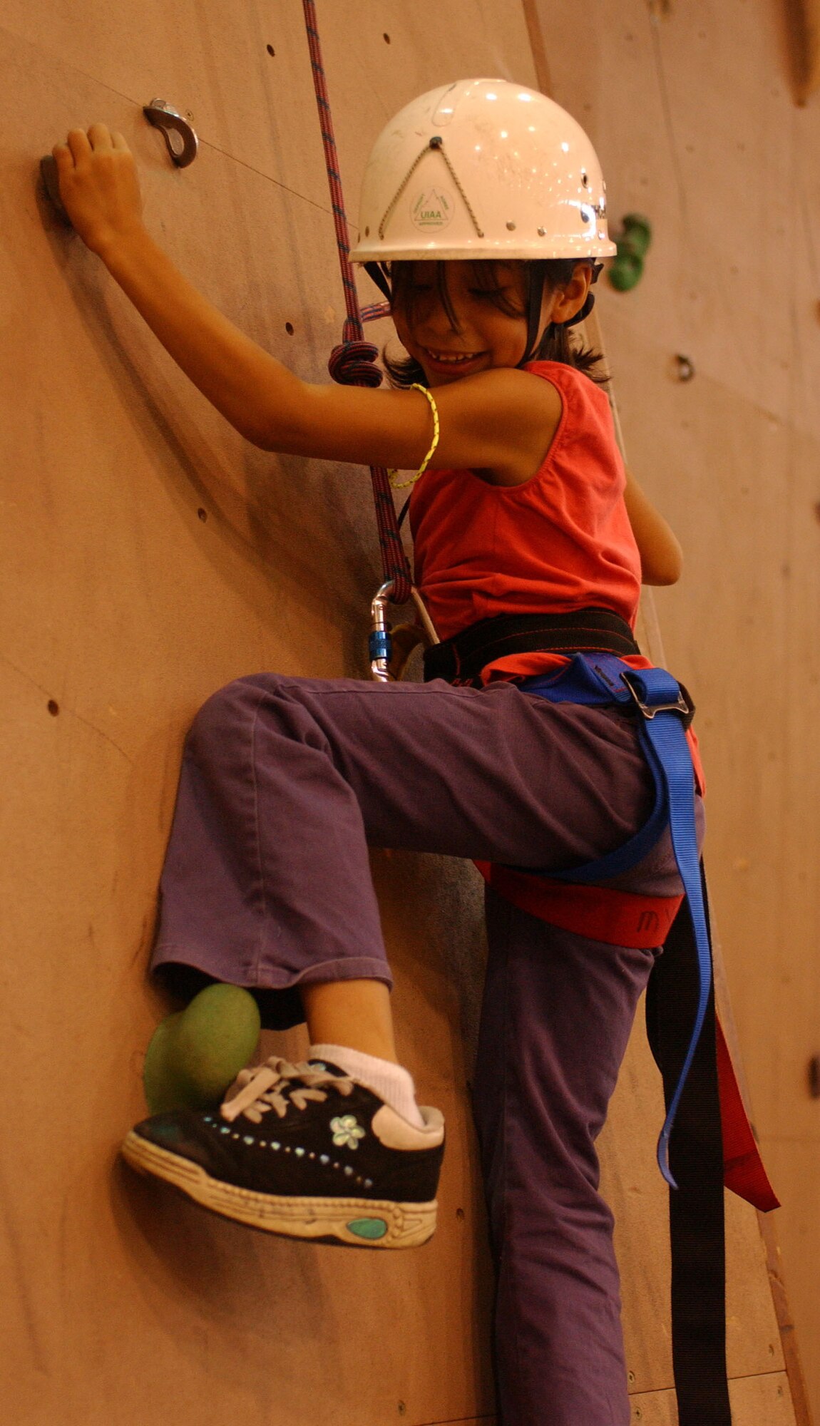 Carly Carrillo, 7, makes her way up a climbing wall during the Operation Together & Ready activicty held at the RAF Mildenhall Child Development Center June 9, 2007.  (U.S Air Force photo by Airman Brad Smith)                                     