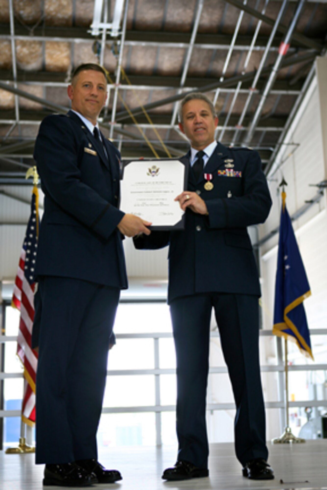 GRISSOM AIR RESERVE BASE, Ind., -- Col. Stan Sheley, the 434th Maintenance Group Commander, presents a certificate of retirement to Lt. Col. Antonio Lopez, Jr. Colonel Lopez served the Air Force for over 29 years. He retires as the Deputy Commander of the 434th Maintenance Group at Grissom Air Reserve base. (U.S. Air Force photo/Senior Airman Omar Delacruz)